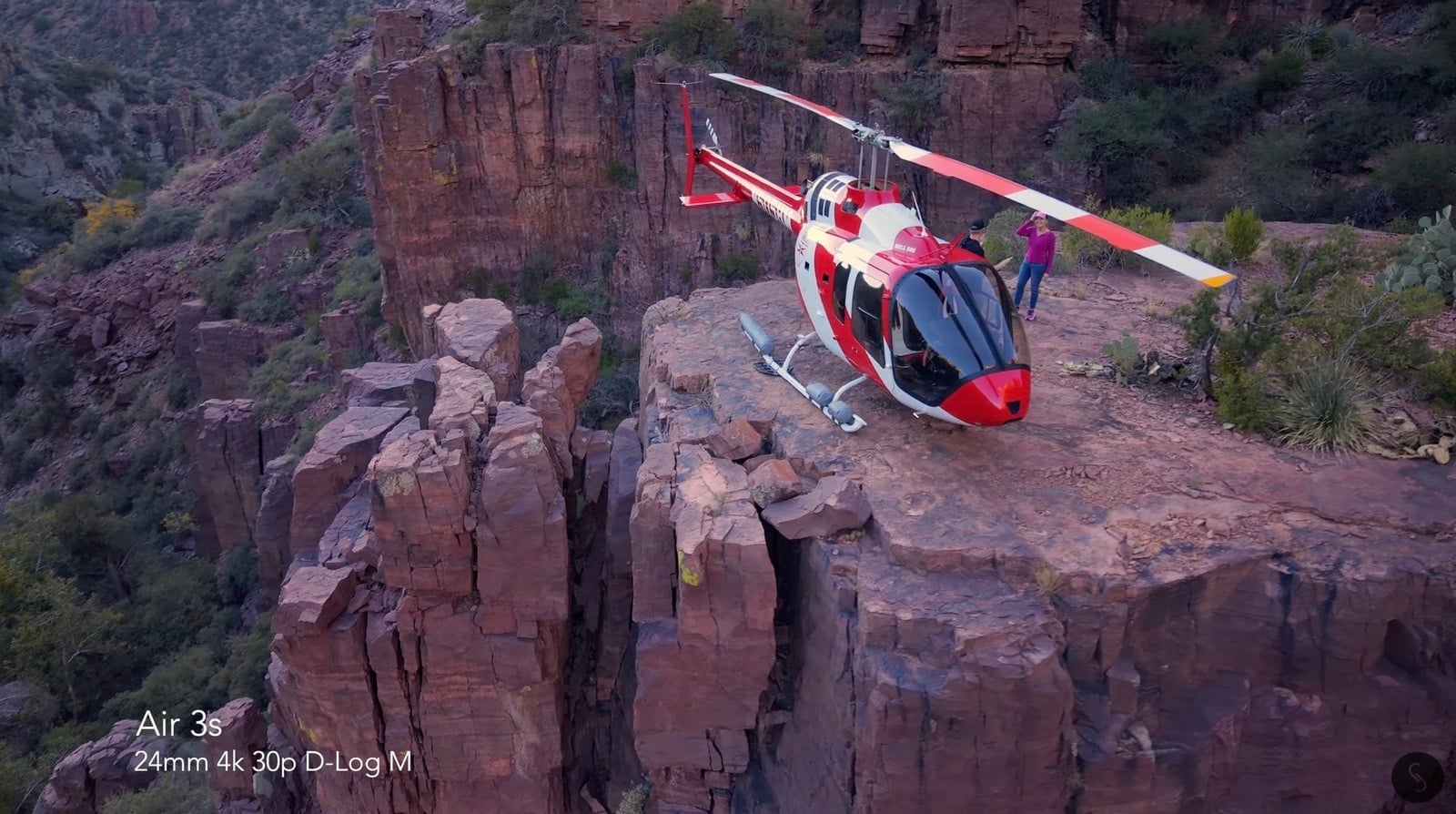 Air 3S sample shot of a red and white helicopter parked on a canyon ledge.