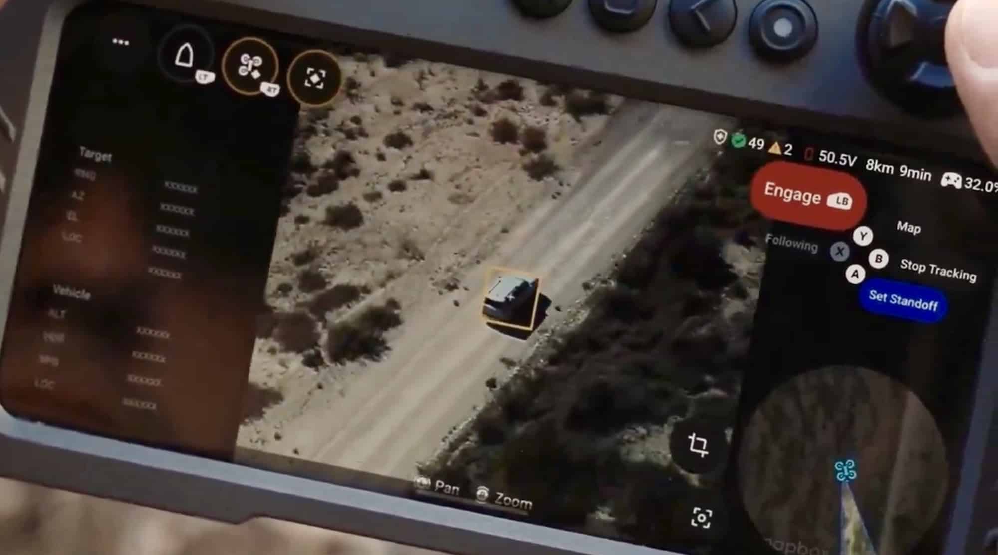 Tablet running a targeting interface with an engage button over a tracked vehicle.