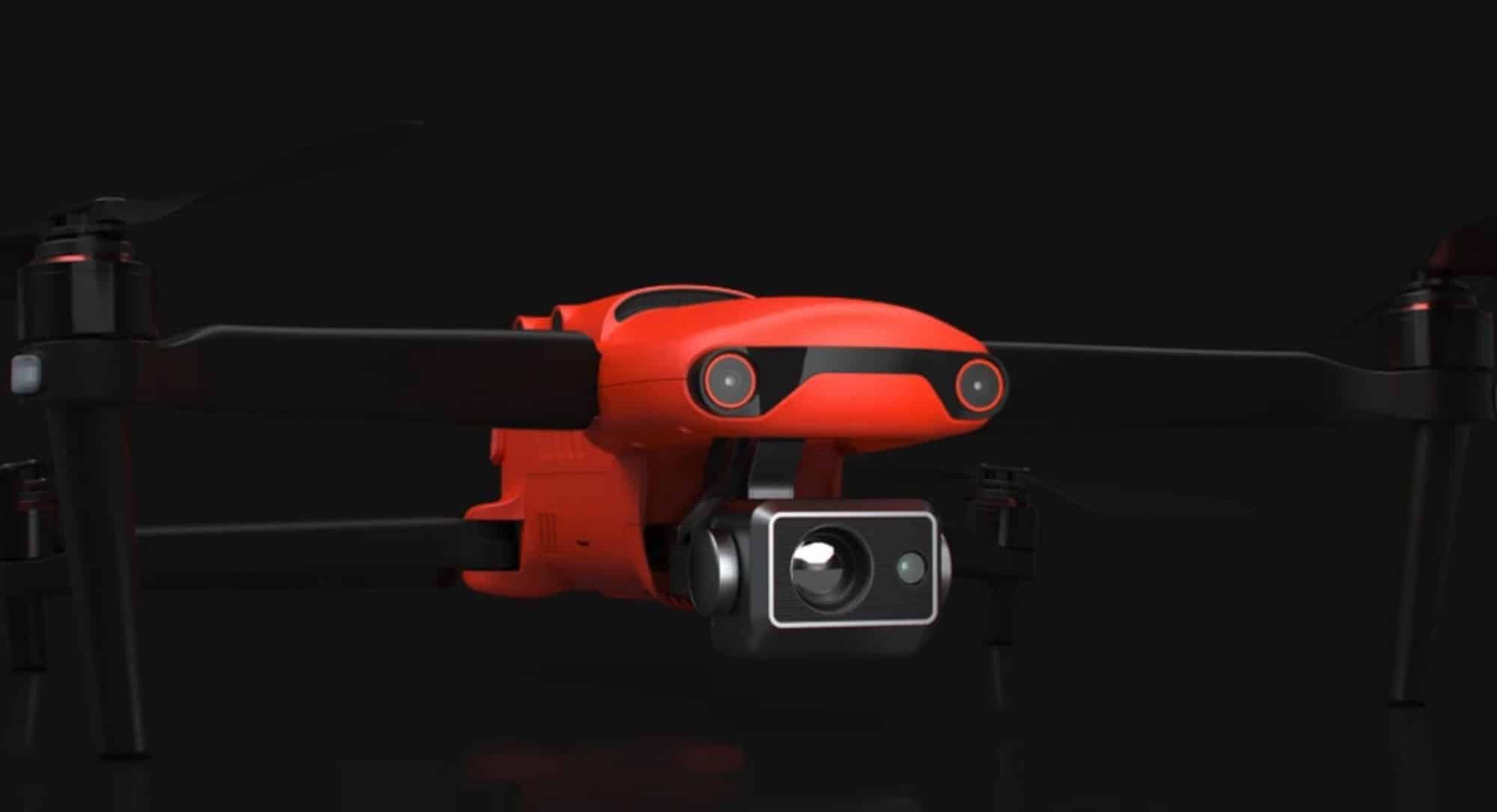 Orange Autel enterprise quadcopter with a thermal and zoom gimbal on a black backdrop.