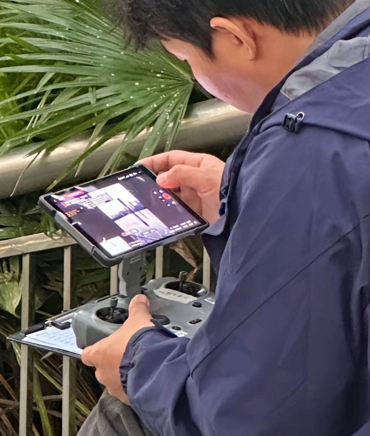 Person outdoors operating the unannounced DJI controller with its large mounted display.