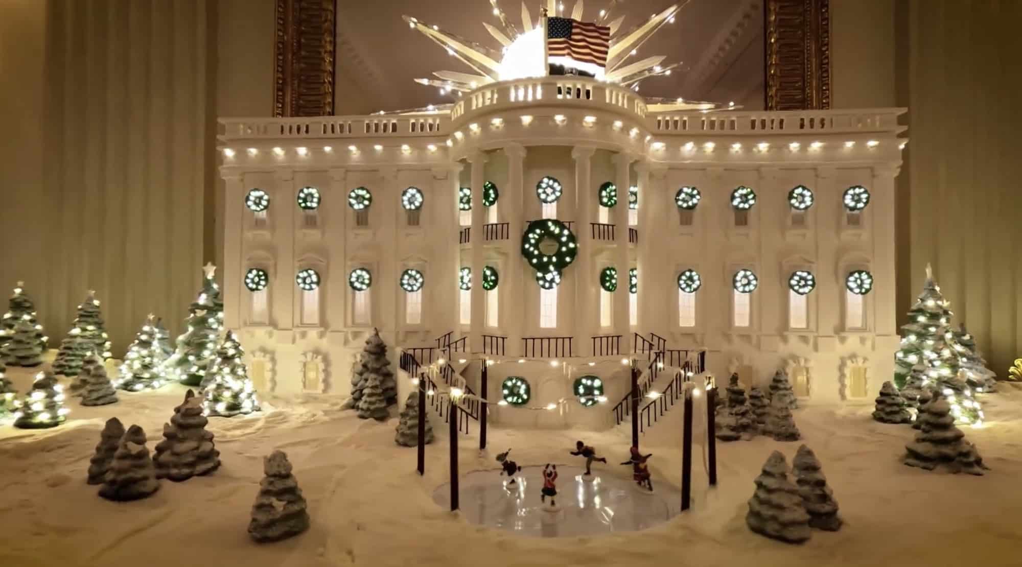 Gingerbread White House model with lit windows, wreaths and sugar-frosted Christmas trees.