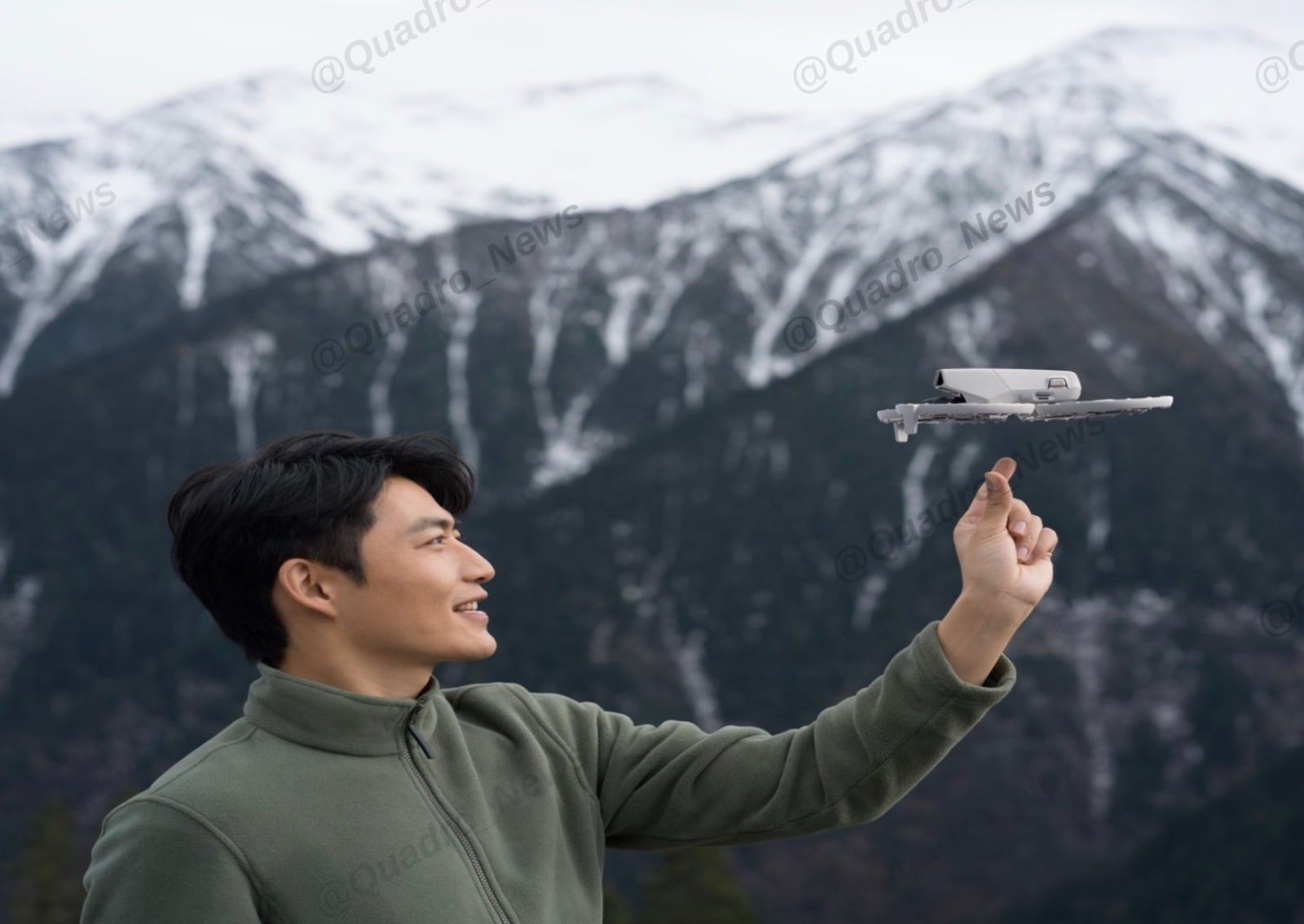 Man launching the folded Flip from his fingertip below snow-capped peaks.
