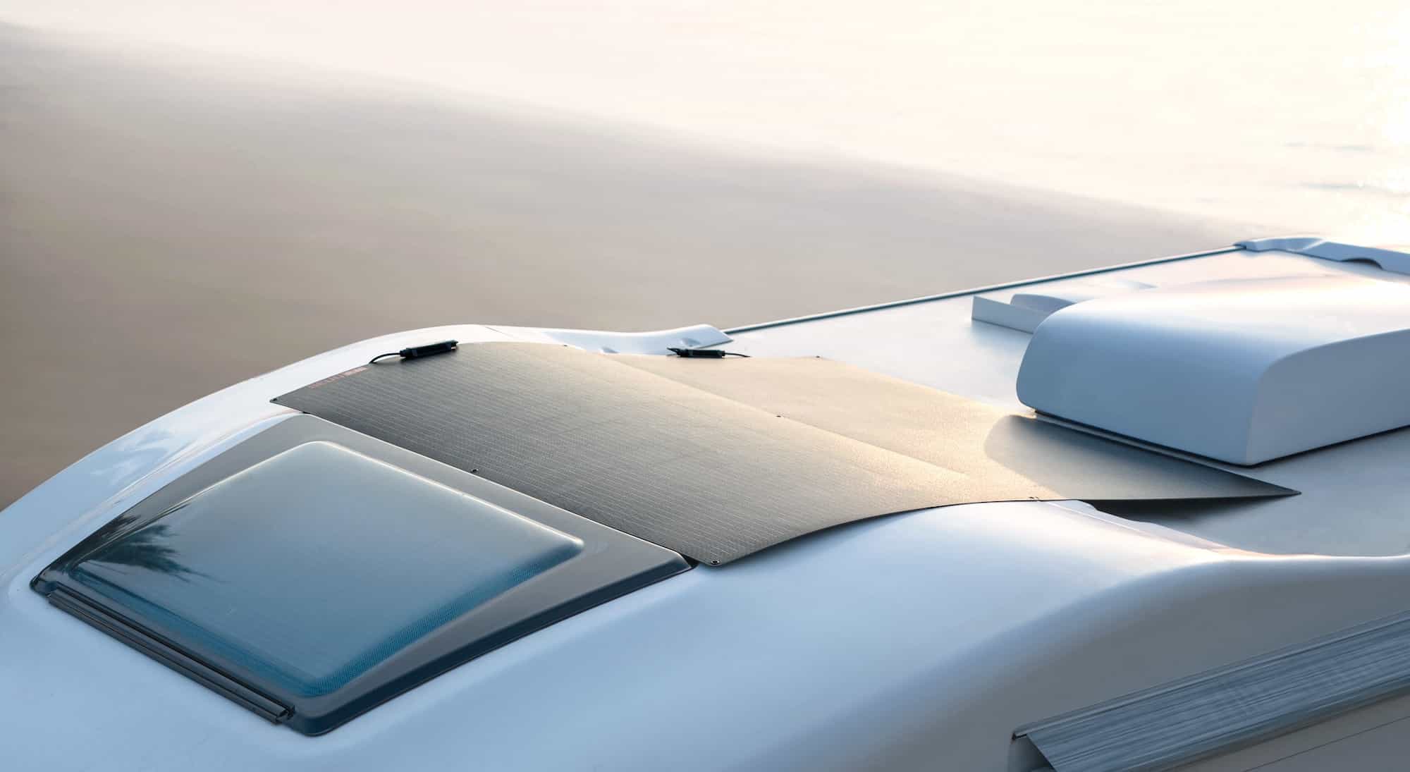 Folding solar panel deployed on the roof of a recreational vehicle.
