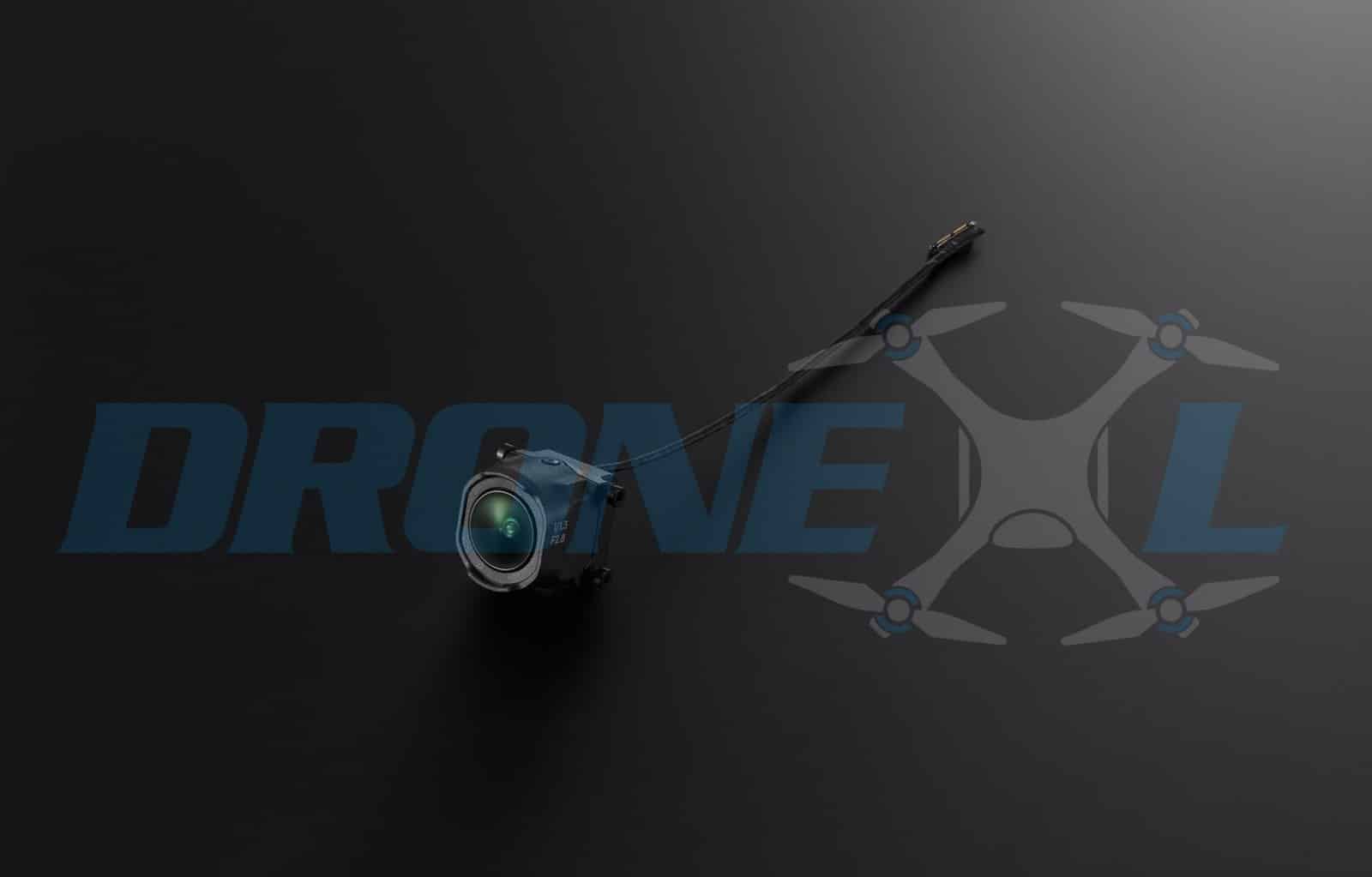 Close-up of the tracking lens and its antenna wire on black.