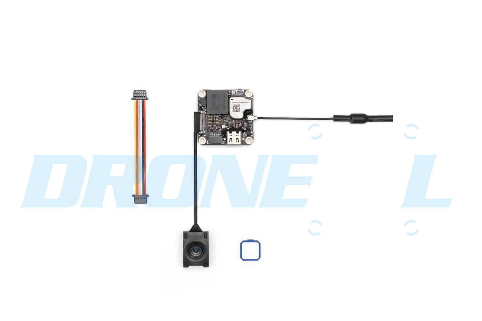 Flat-lay of the module's board, antenna lead, lens unit and blue seal.