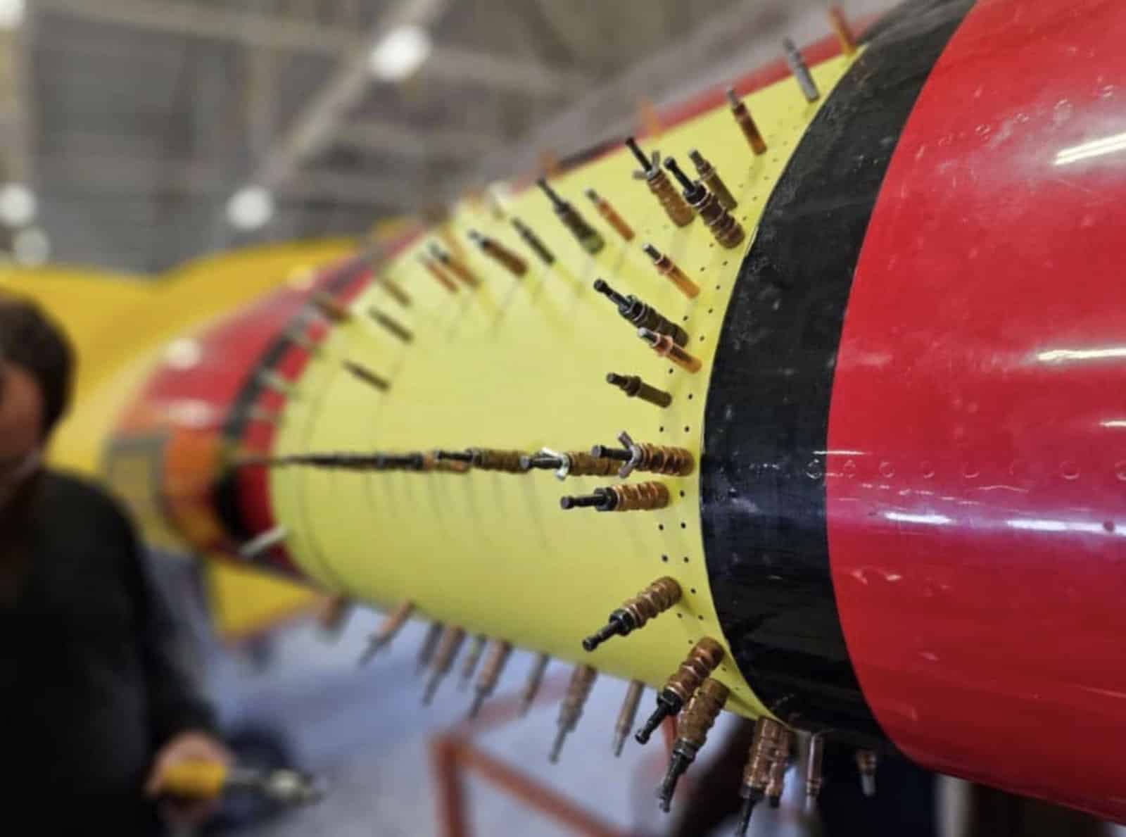 Rows of copper clecos hold new panels along the yellow and red wingtip.