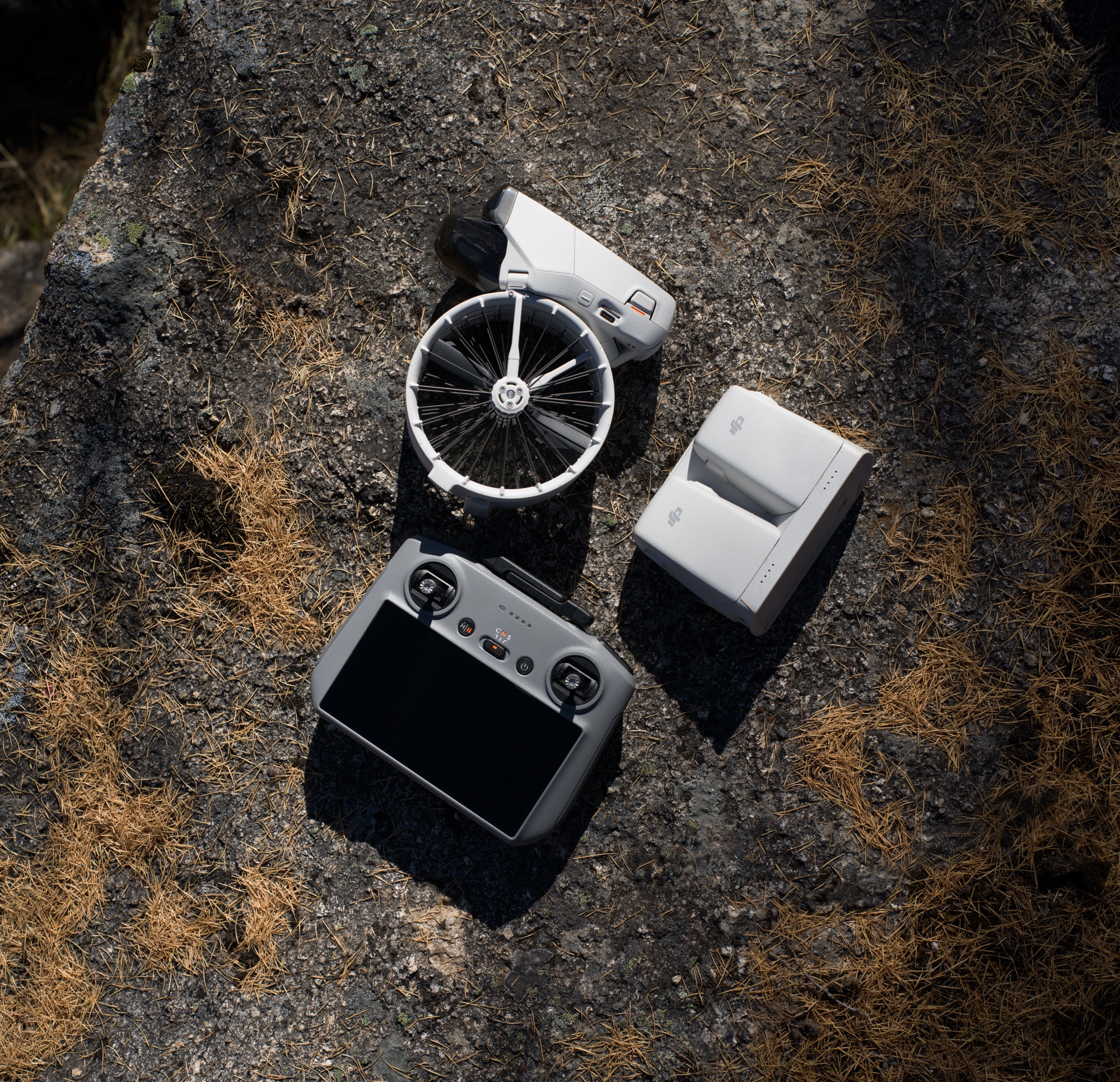 Overhead flat lay of the folded Flip, DJI RC 2, battery and charging hub.