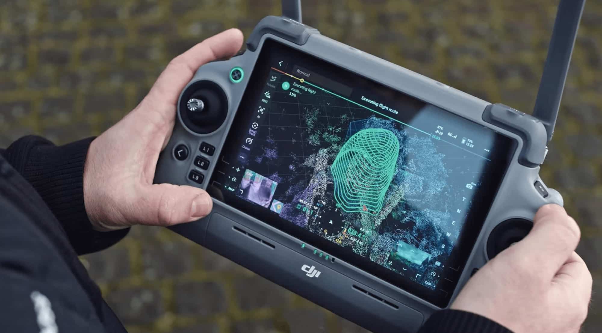 Operator holding a controller showing a green 3D capture route over point-cloud data.
