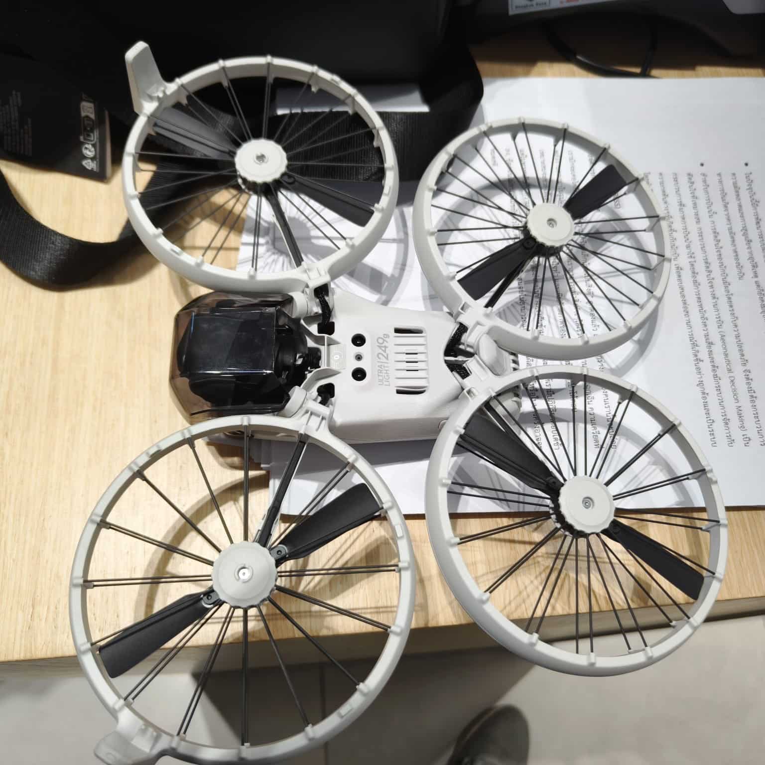 Leaked photo of the white DJI Flip unfolded on a desk, propeller cages exposed.