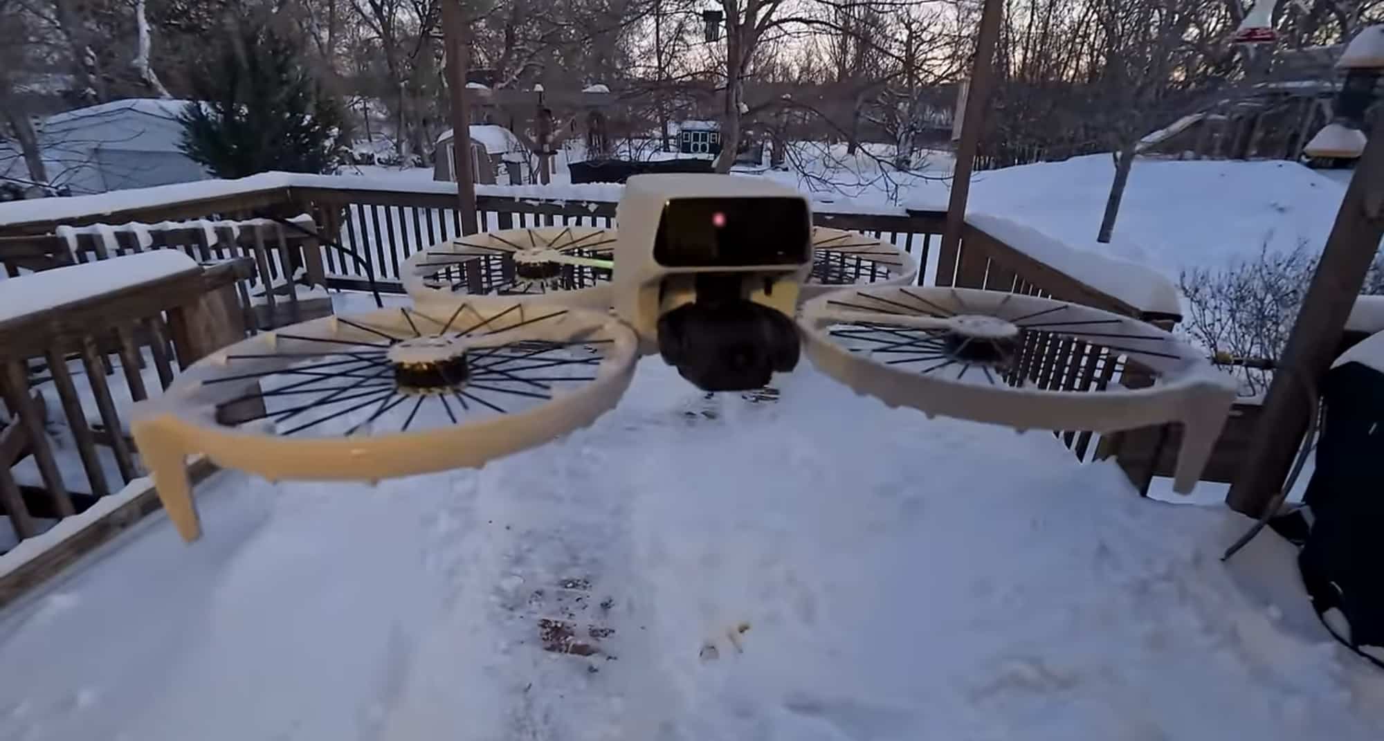 Low-angle view of the Flip parked on a snowy backyard deck at dusk.