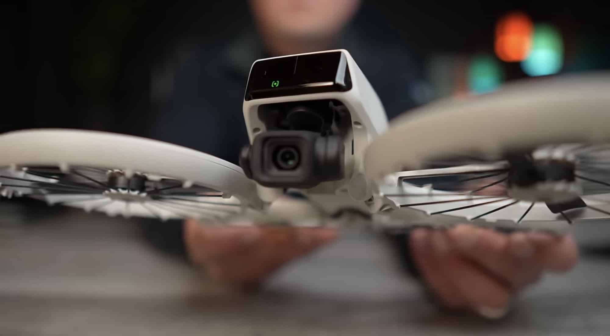 Close-up of the gimbal camera framed by blurred propeller cages.