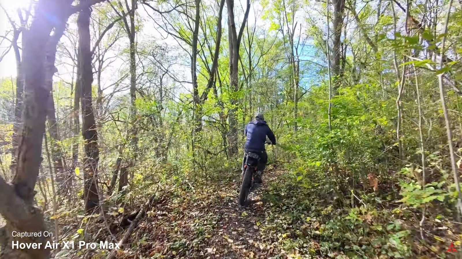 The HoverAir X1 Pro following its subject along a trail in autonomous tracking mode.
