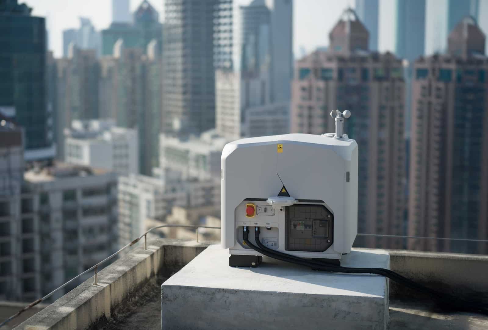 Dock bolted to a concrete rooftop pad with a dense city skyline behind.