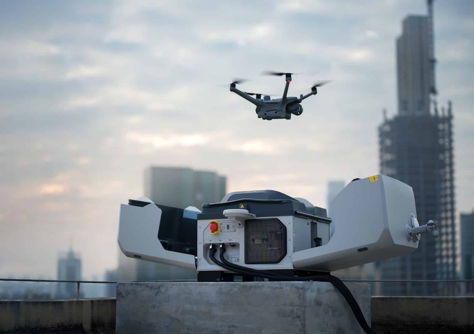 Drone hovering over the rooftop dock with skyscrapers and a tower crane behind.