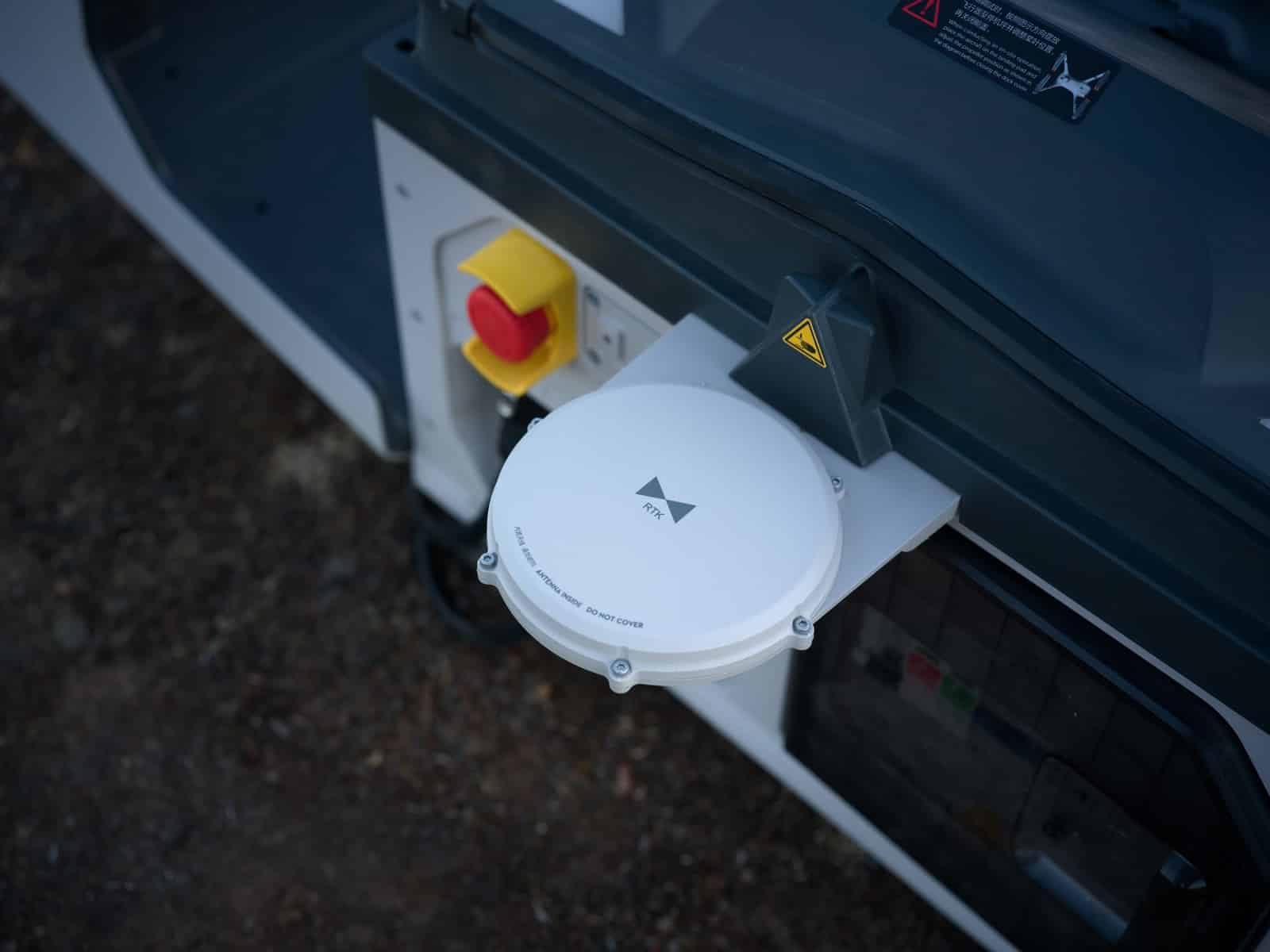 Detail of the white antenna dome folded flat against the dock body.