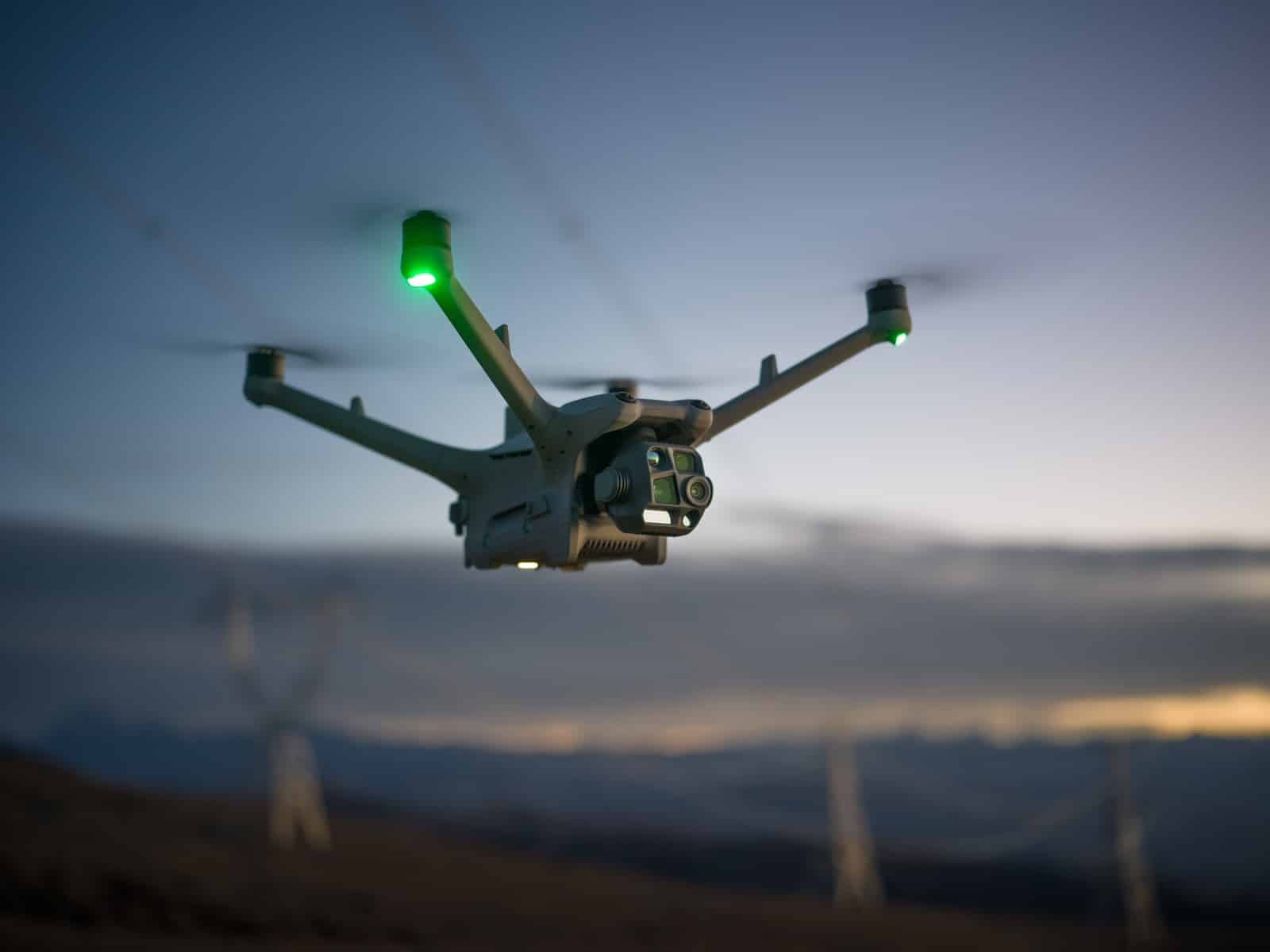 Tight view of the aircraft dual-sensor gimbal payload during twilight flight.