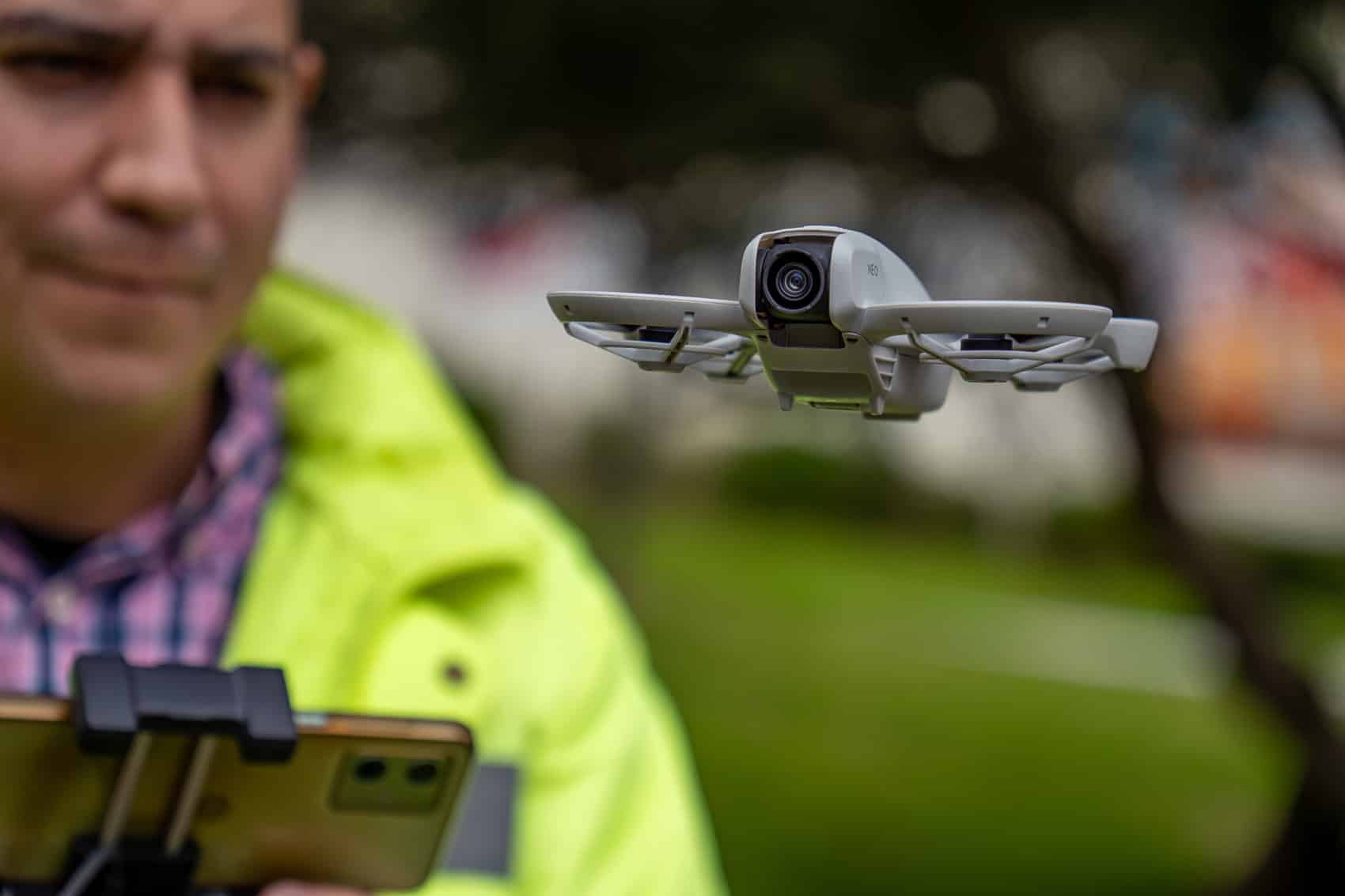 Man flying a Dji Neo with a RC-N3 controller