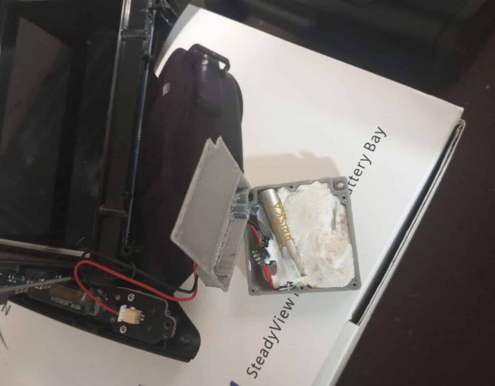Disassembled FPV goggles beside the modified compartment on a labeled manual page.