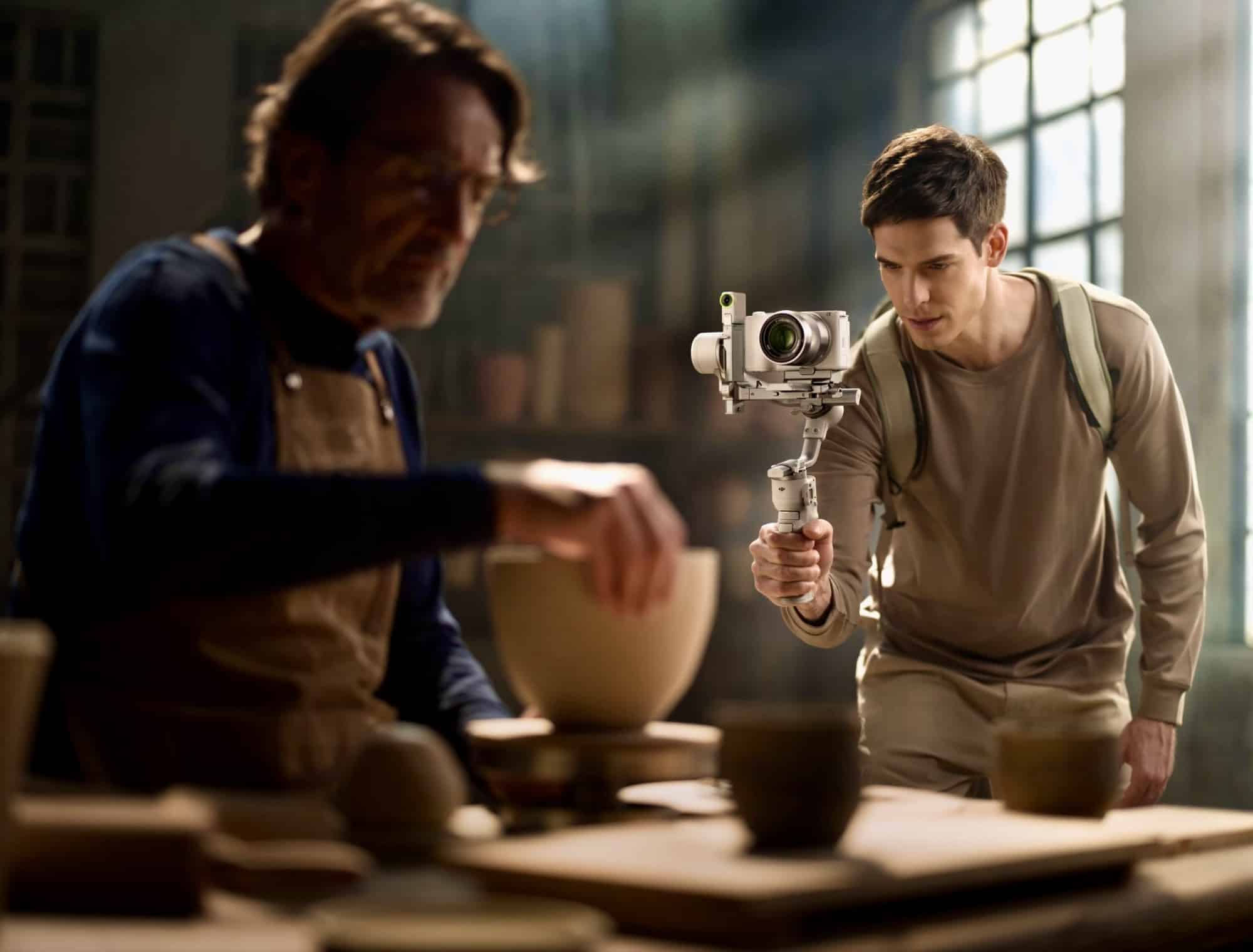 A videographer films a potter at his wheel with the white gimbal.