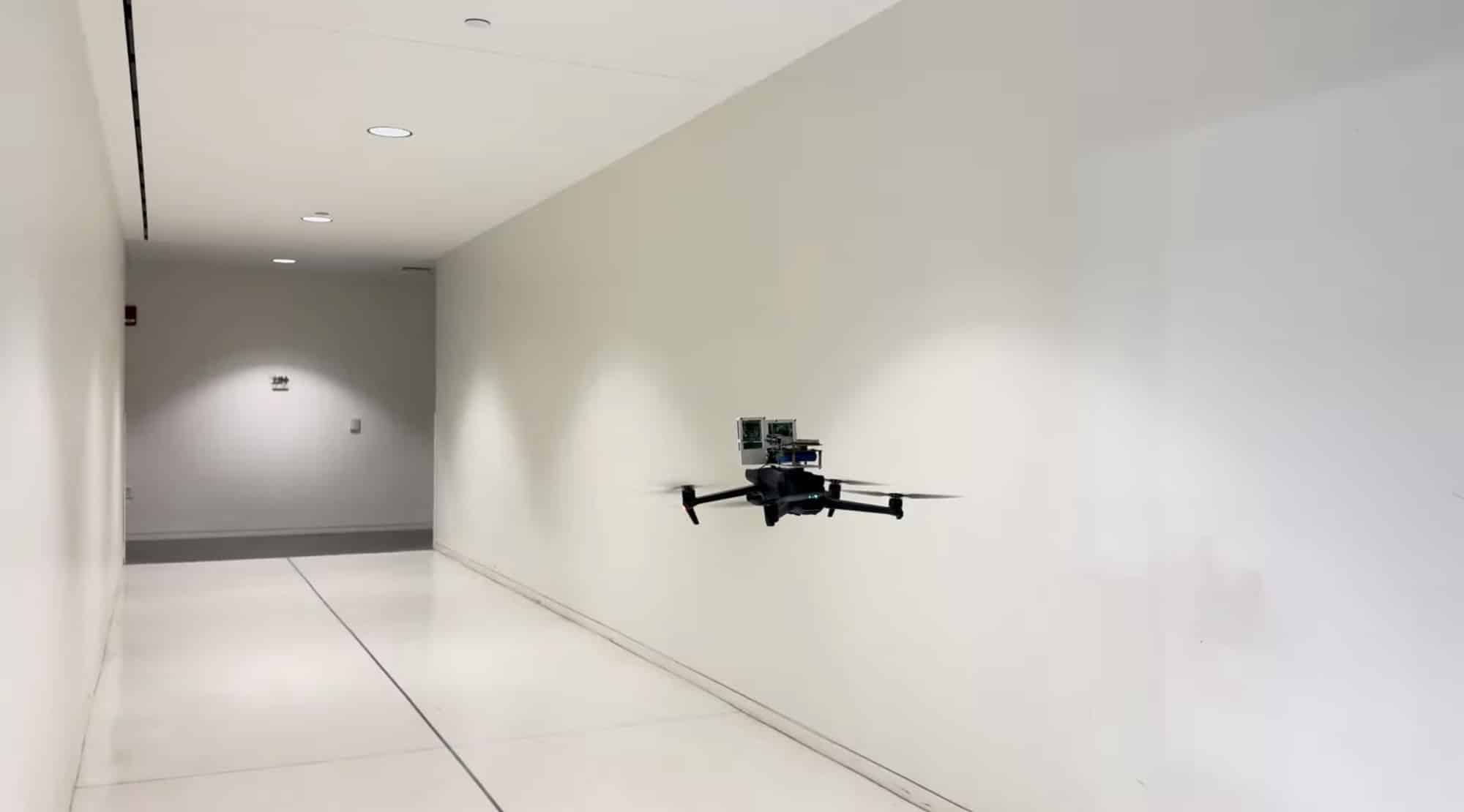 Quadcopter hovers along a featureless white corridor with no visual landmarks.