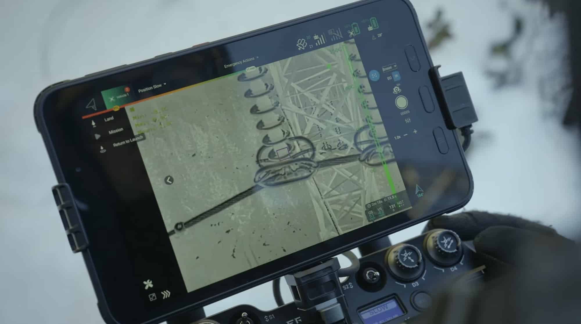 A rugged ground-station tablet displays live lidar point cloud data in the pilot's hands.