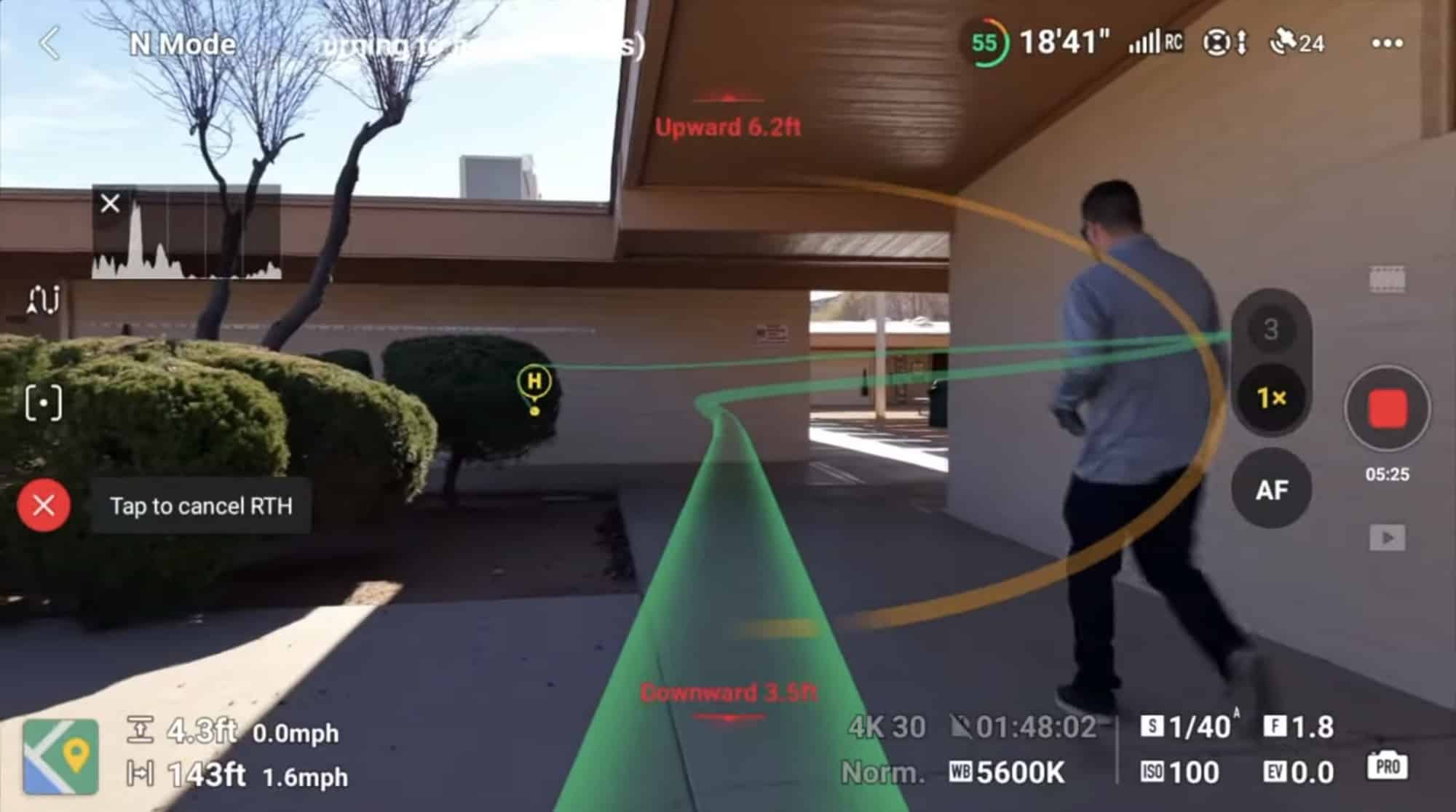 DJI Fly screen showing the return-to-home path arcing toward a walking man.