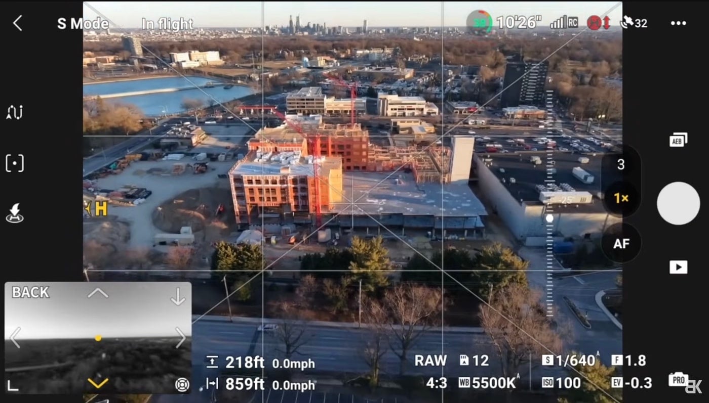 Flight screen shows a sunset town at 218 feet (66 meters) with exposure readouts.