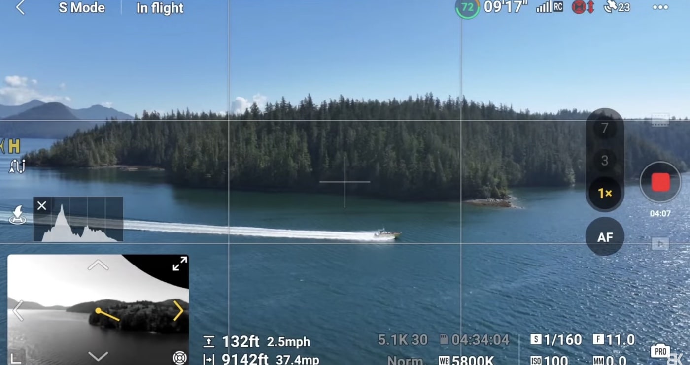 Flight screen shows a forested shoreline and boat wake with a histogram overlay.