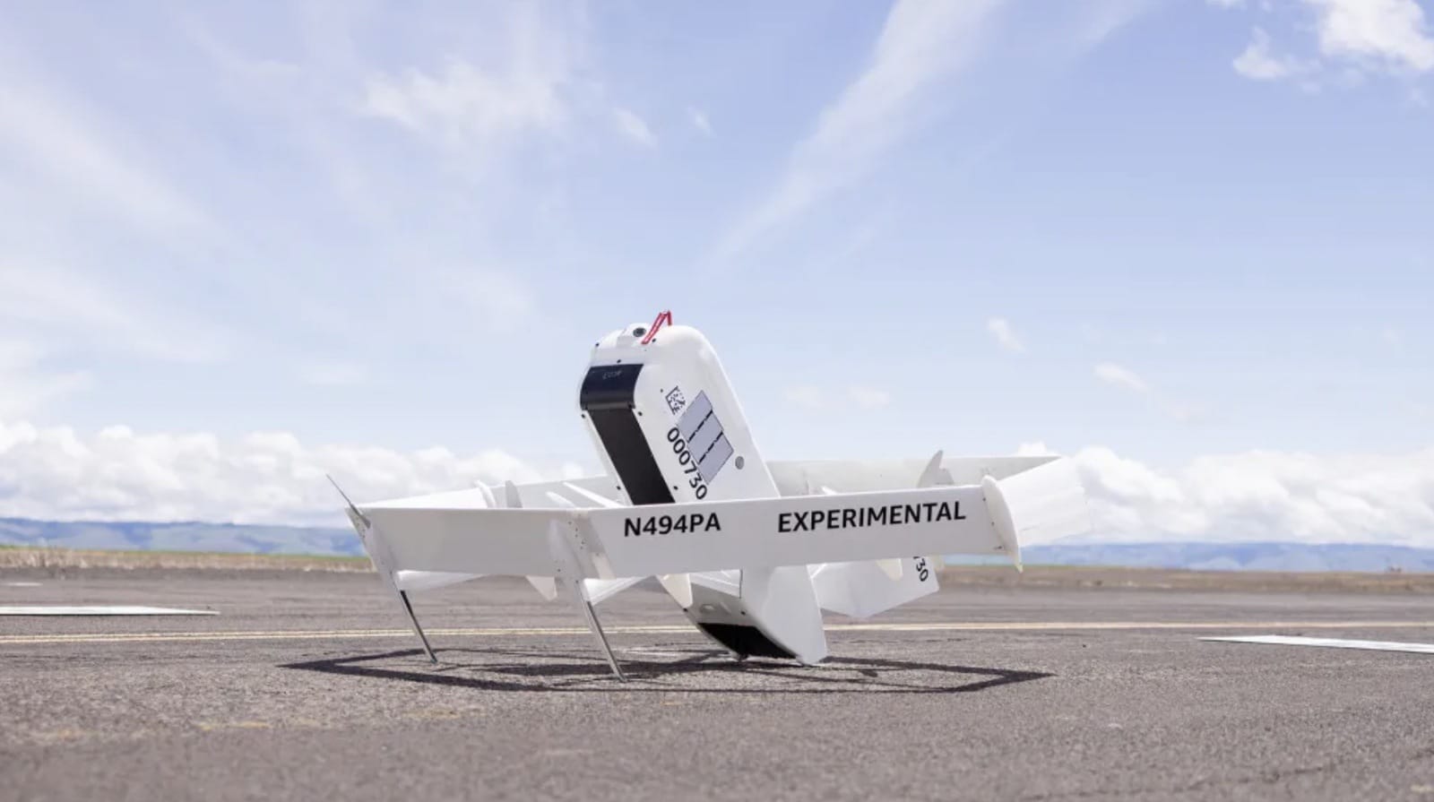 An Amazon delivery drone in cruise flight as Wing and DroneUp scale up.