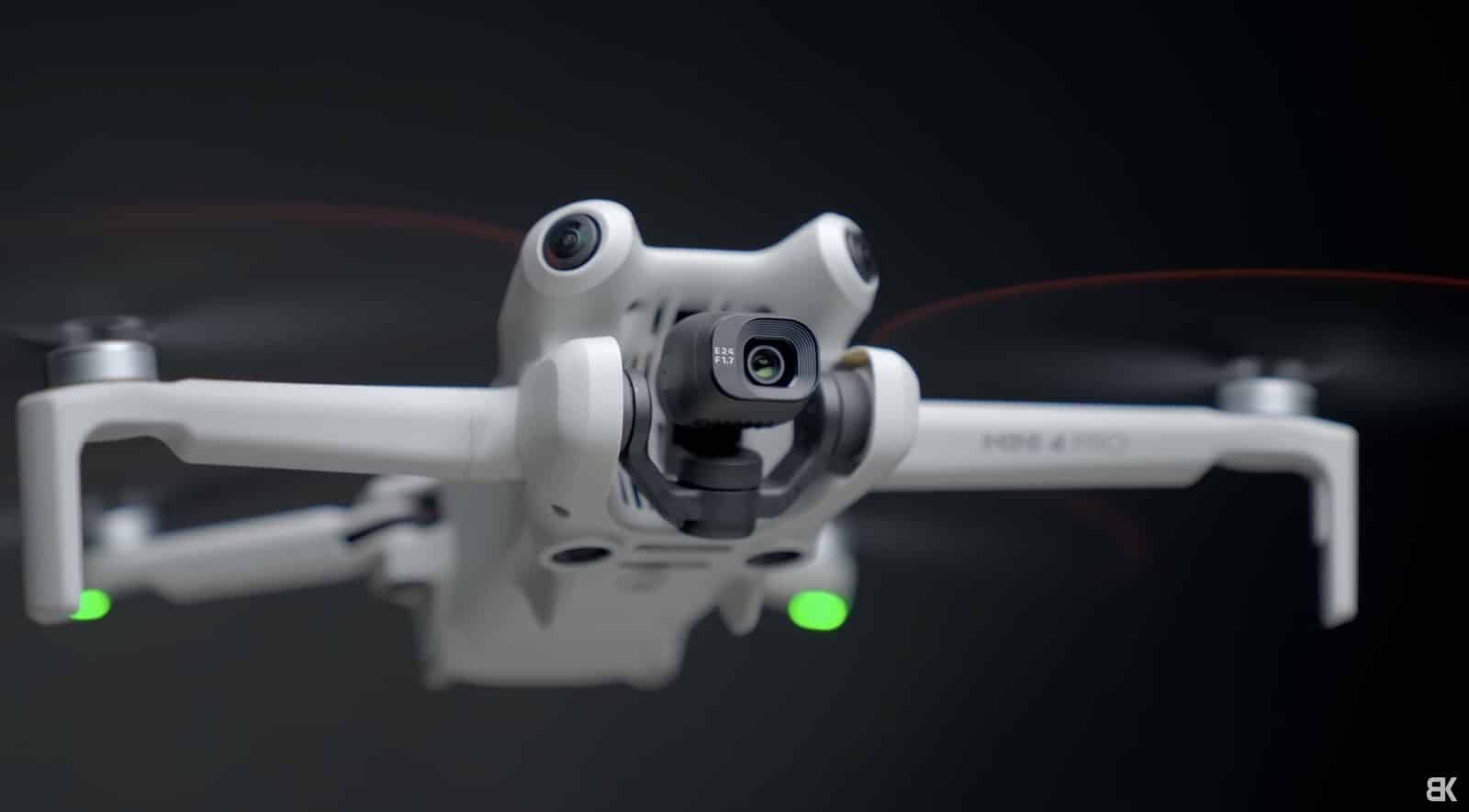 A white Mini 4 Pro at an angle with green landing lights lit.
