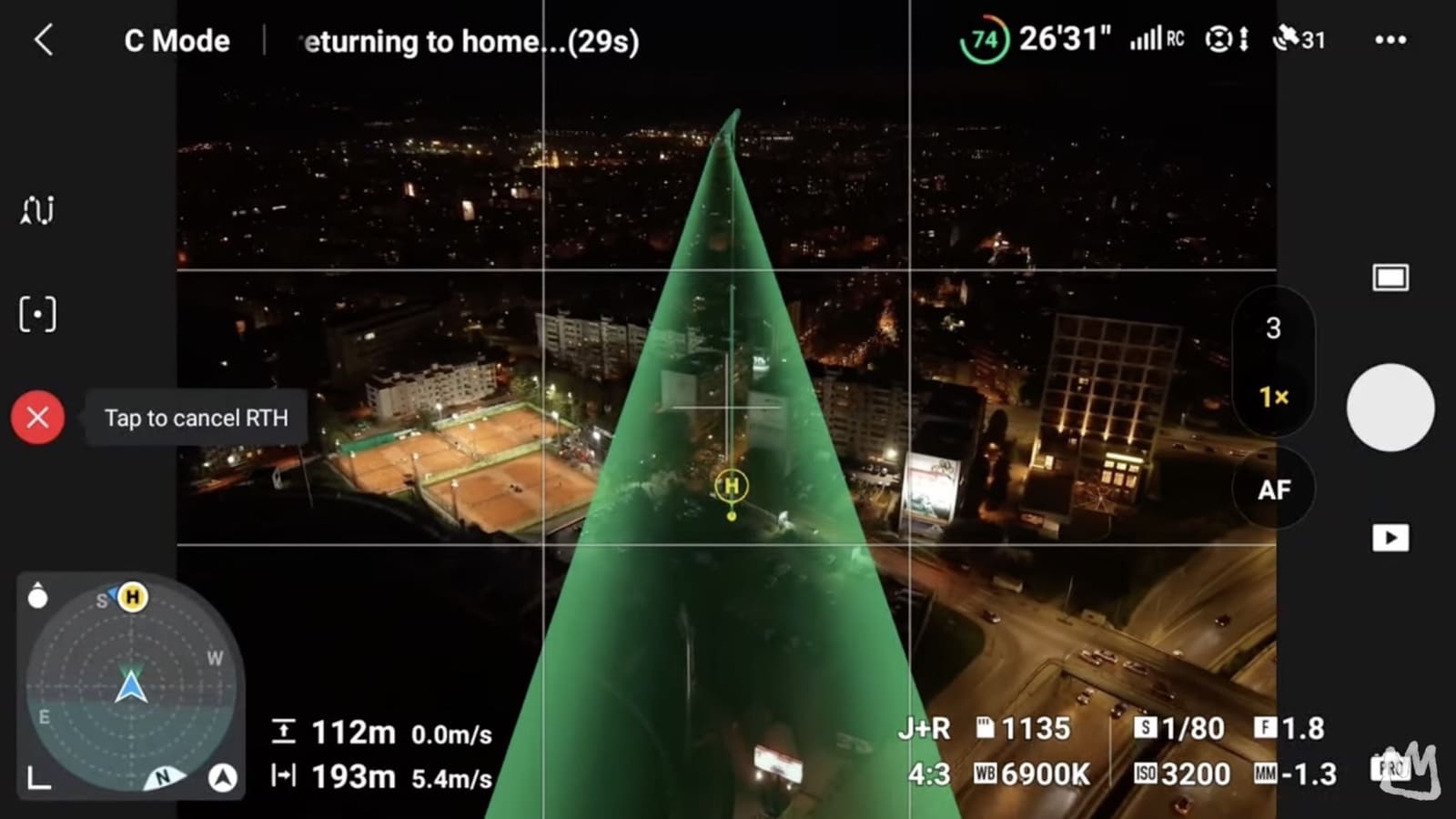 Night flight screen with a green return-to-home cone drawn over a lit cityscape.