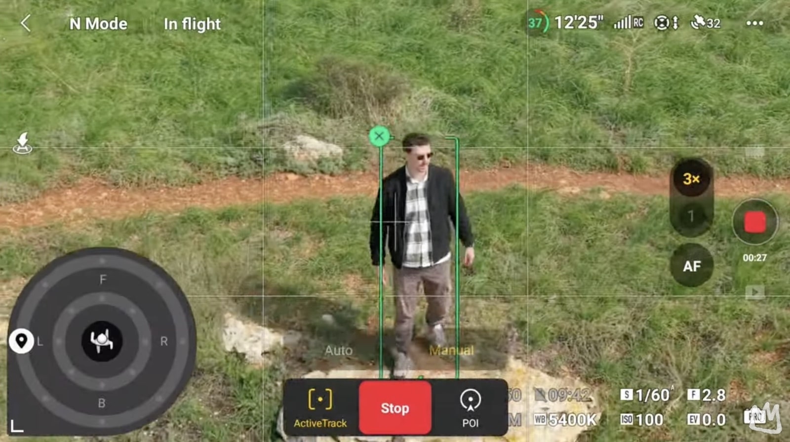 ActiveTrack locking onto a hiker walking a dirt path in the flight app.