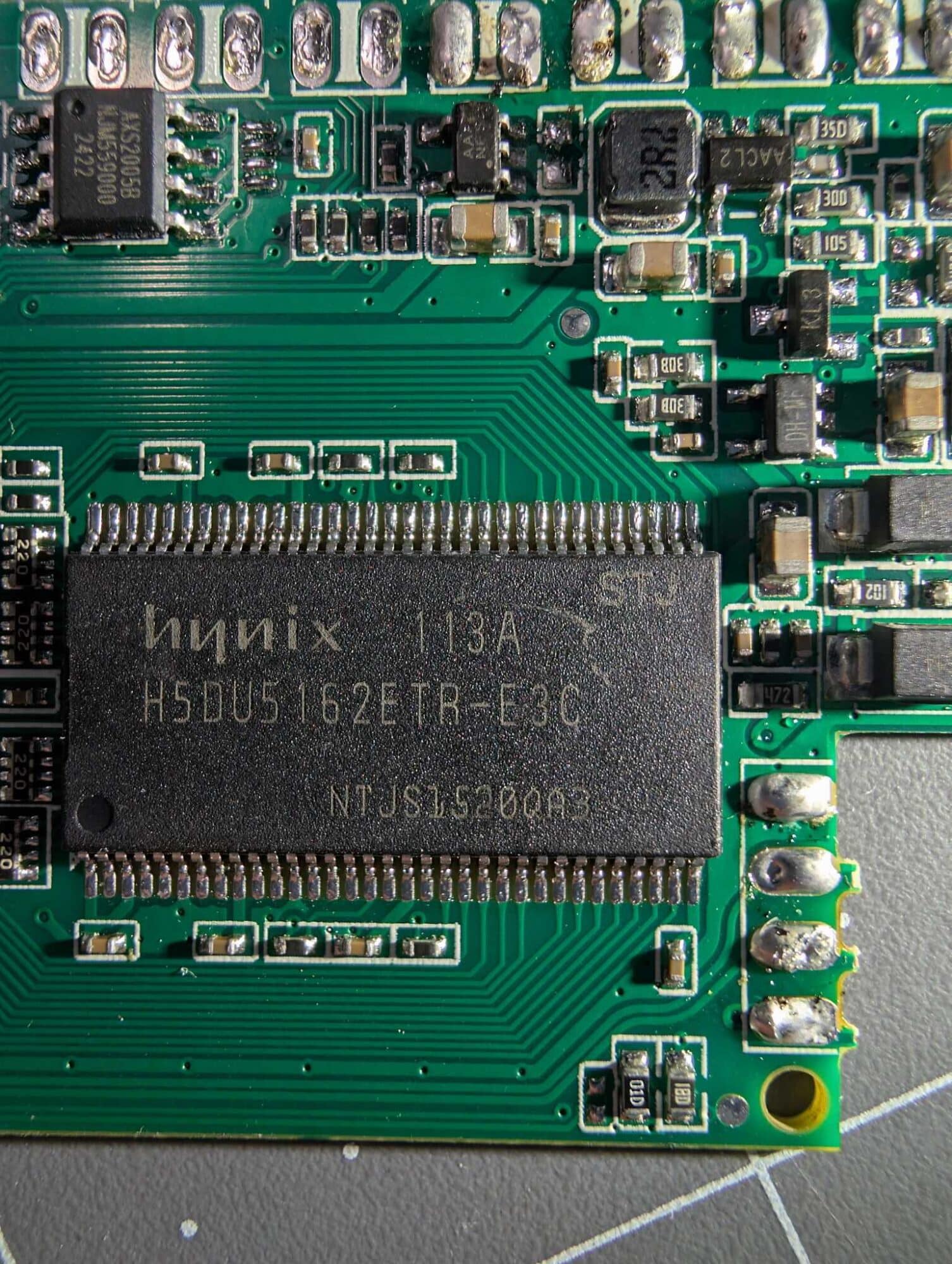 Close-up of a Hynix memory chip soldered beside the board edge connector.