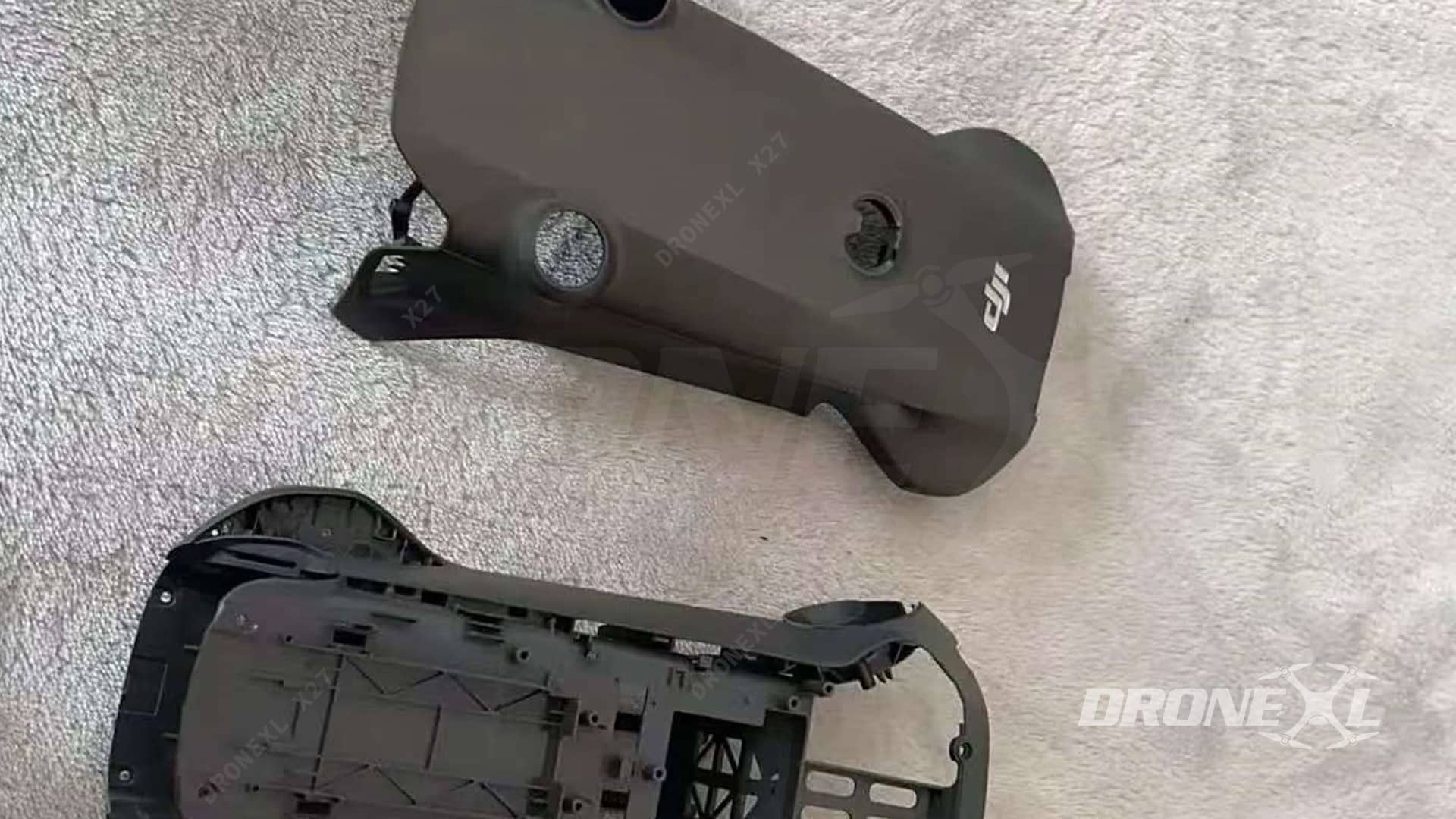 Two empty Mavic 4 Pro body shells resting on a pale cloth.