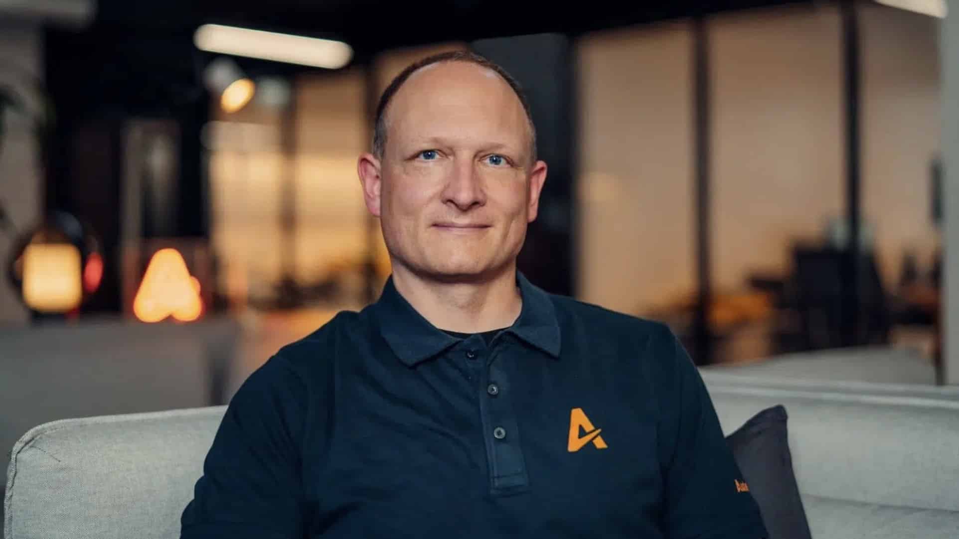 Seated portrait of a man in a dark polo bearing the Auterion logo.