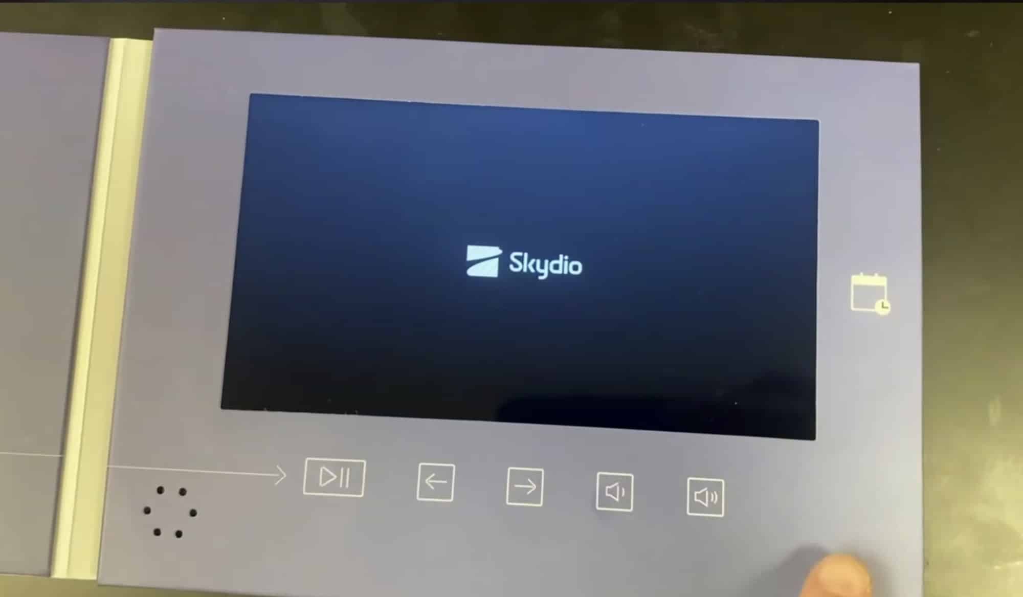 The opened brochure playing a Skydio clip on its embedded screen.