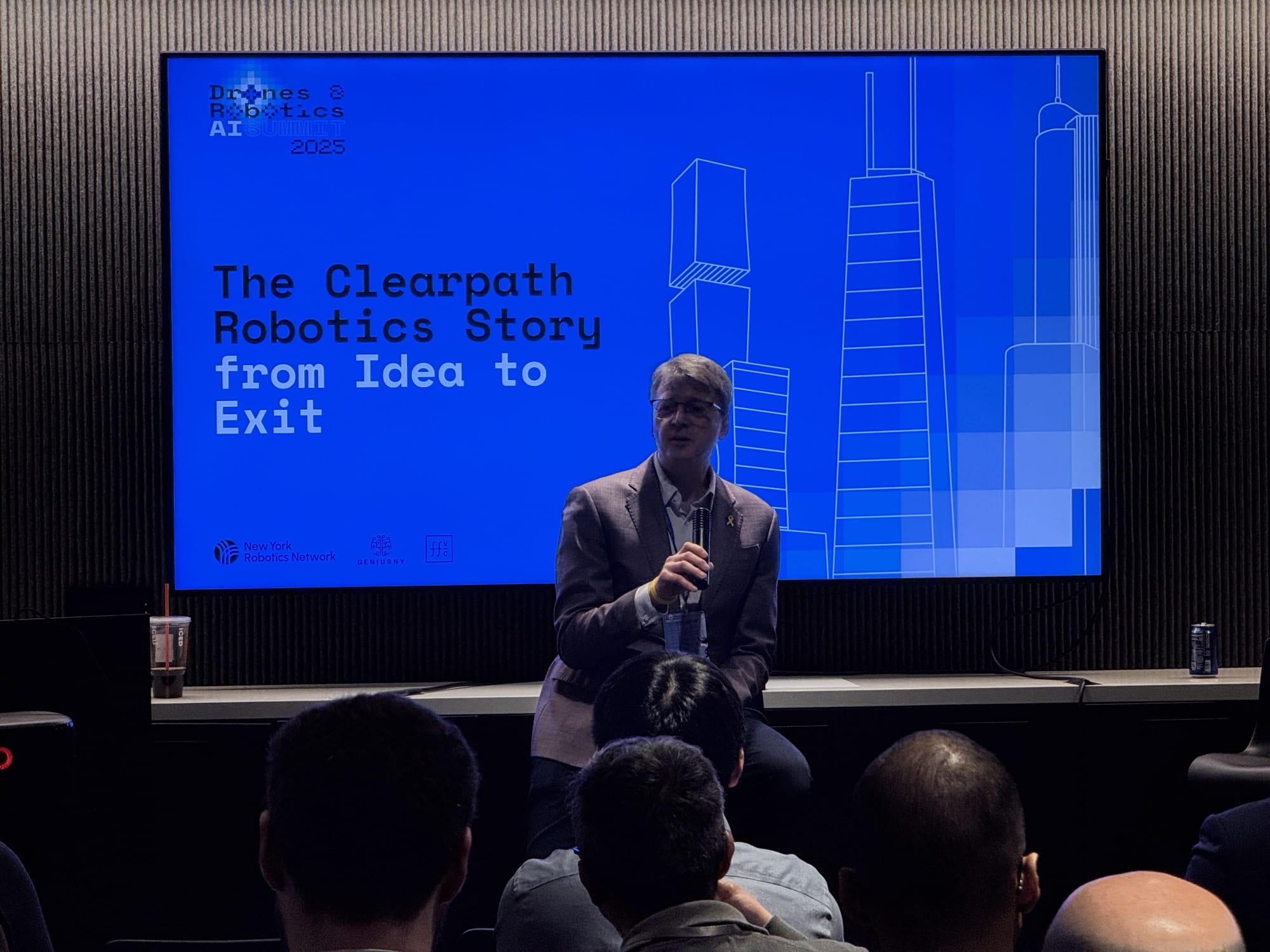 A speaker presents the Clearpath Robotics story from idea to exit.