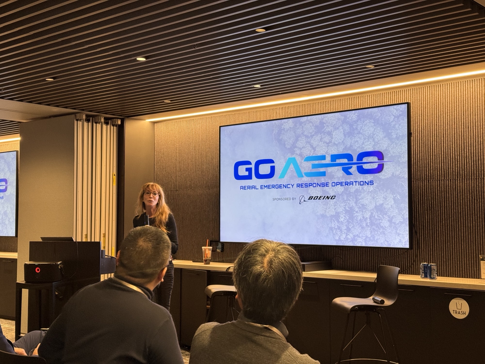 A presenter introduces the GoAERO aerial emergency response prize on a projected slide.