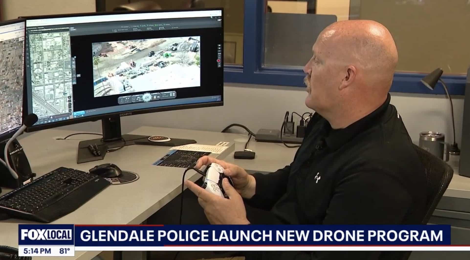 News still of an officer at dual monitors piloting the drone from a desk.
