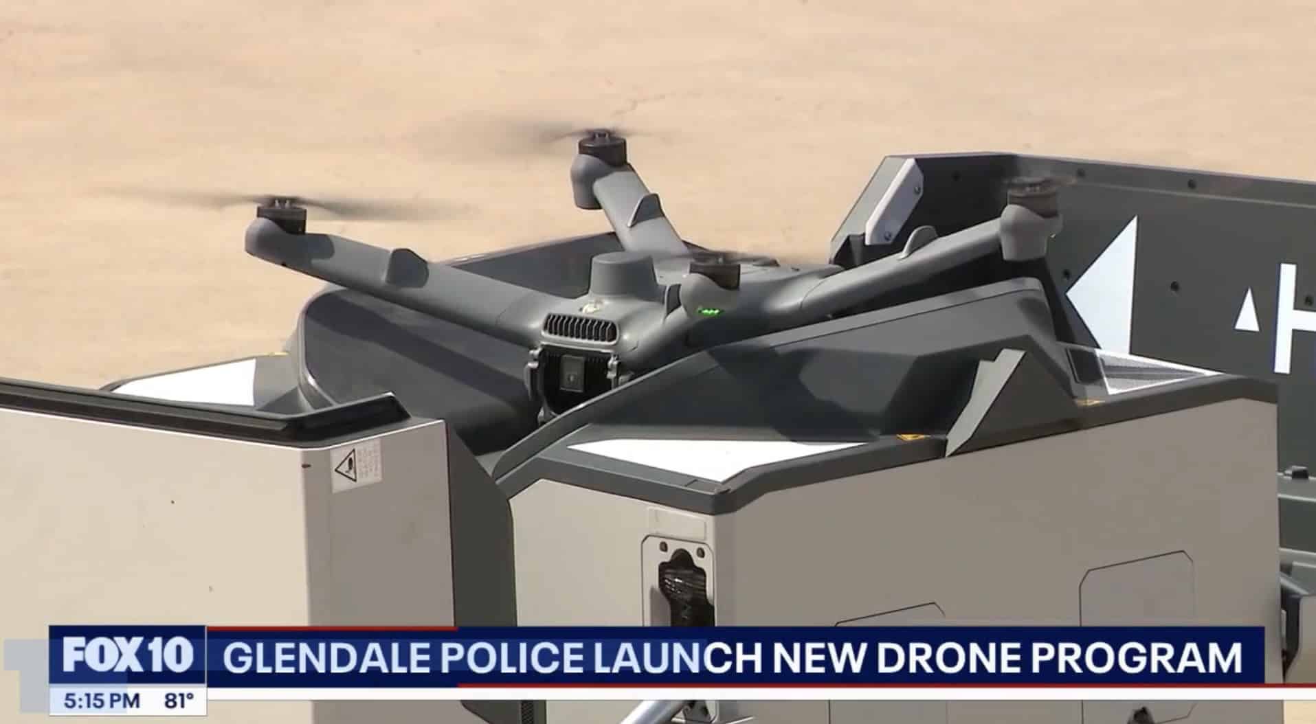 News still of a police drone lifting off a rooftop docking station.