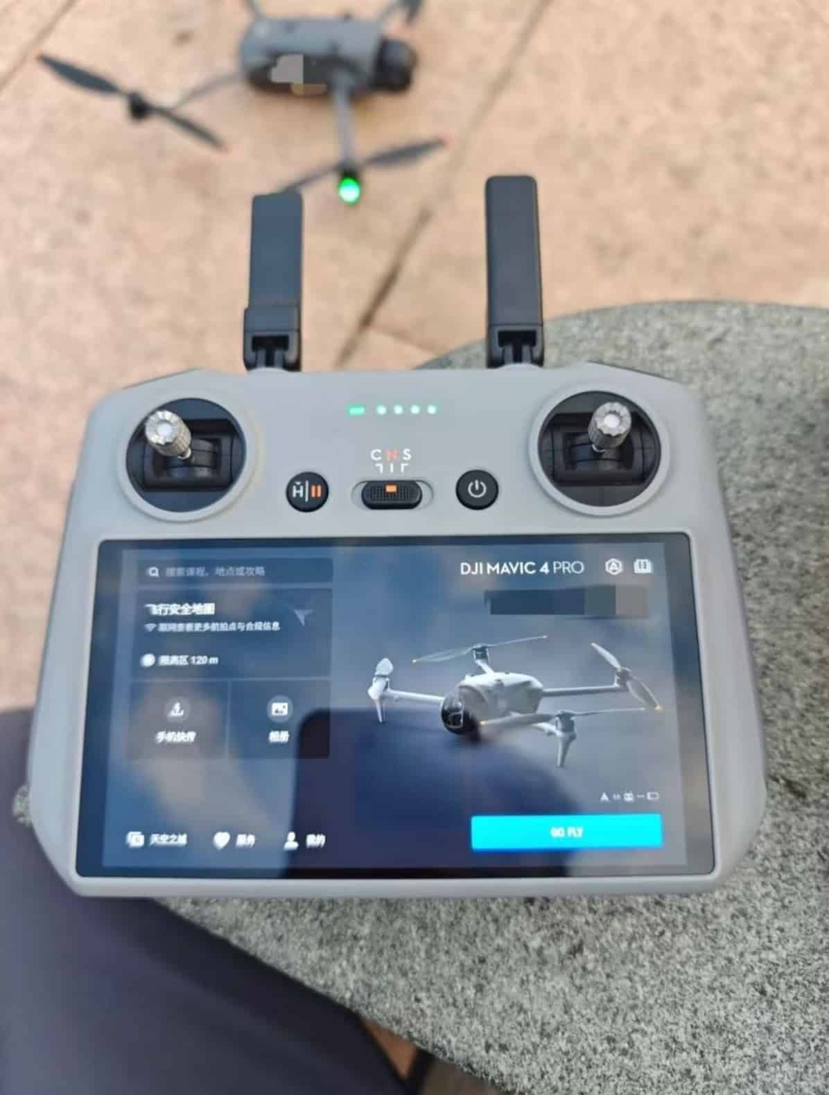 A touchscreen controller on concrete shows a Chinese-language pairing screen for the drone.