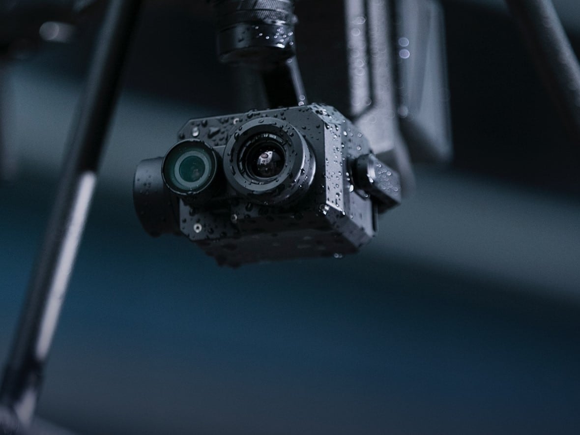 Close-up of a rain-beaded Zenmuse XT2 dual thermal and visual gimbal camera.