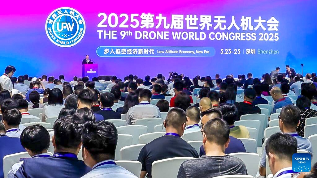 Packed hall faces a screen announcing the 9th Drone World Congress.