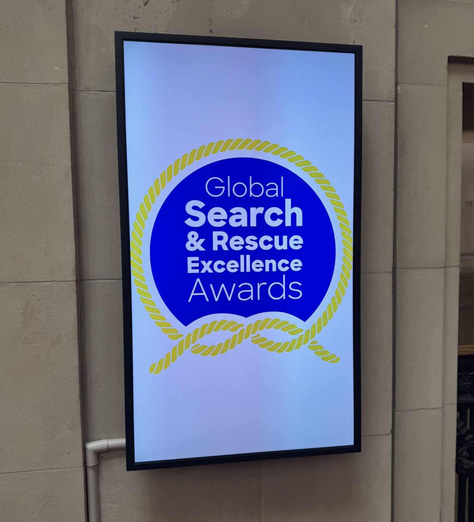 A lobby screen displays the Global Search and Rescue Excellence Awards logo.