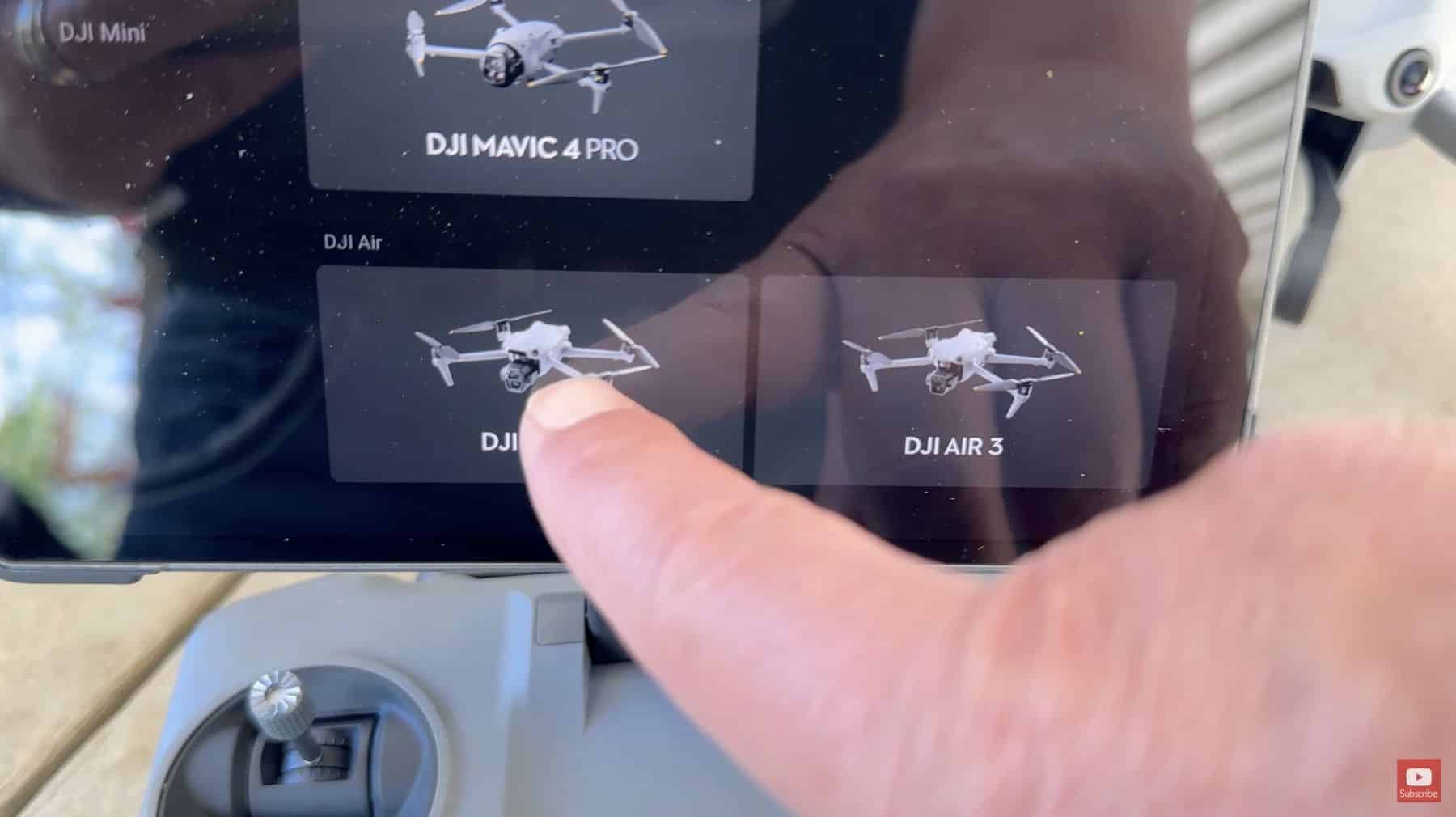 A finger taps the aircraft picker listing Mavic 4 Pro, Mini and Air 3.