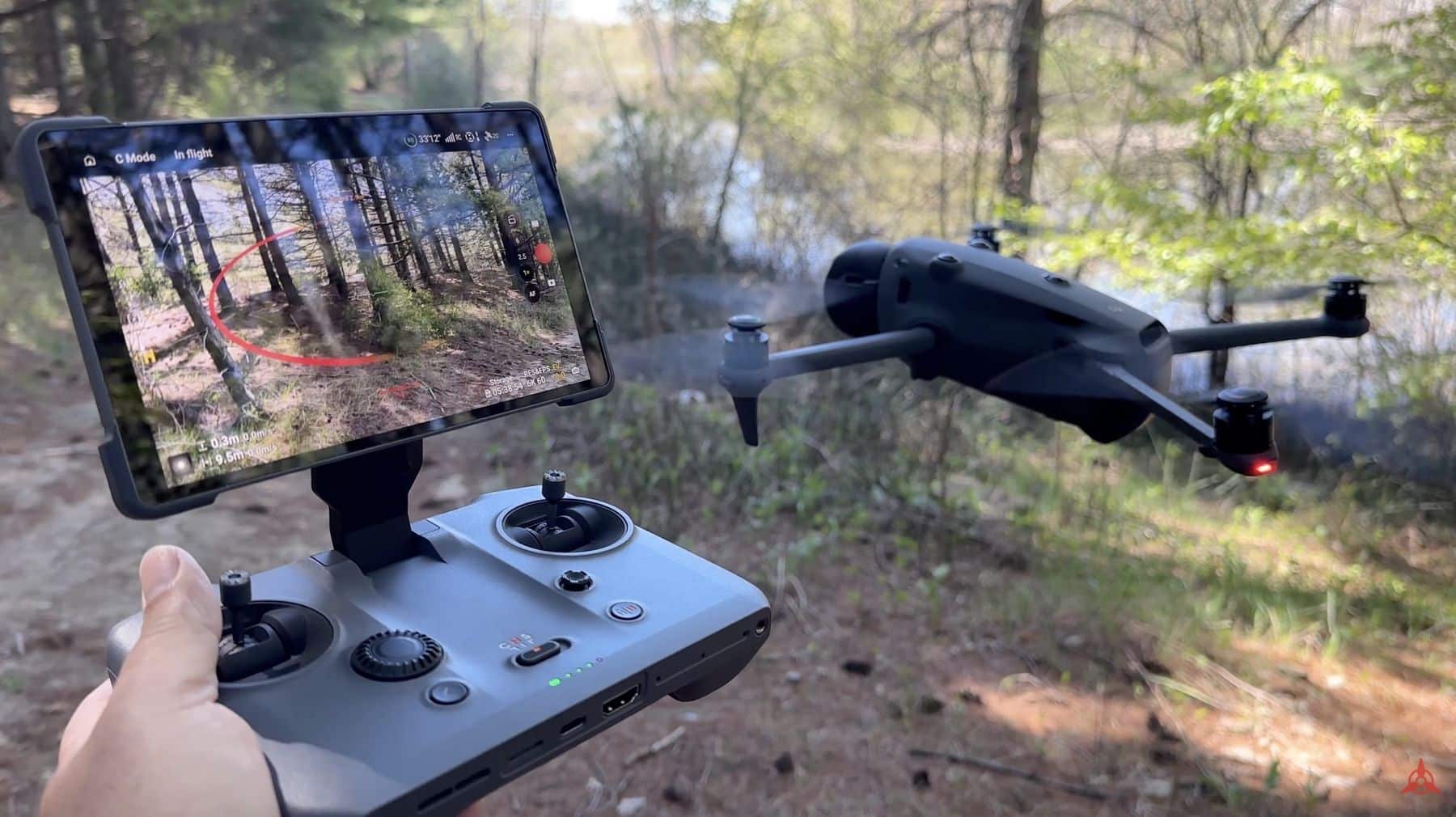 DJI Mavic 4 Pro hovers beside an RC Pro 2 controller showing live forest footage.