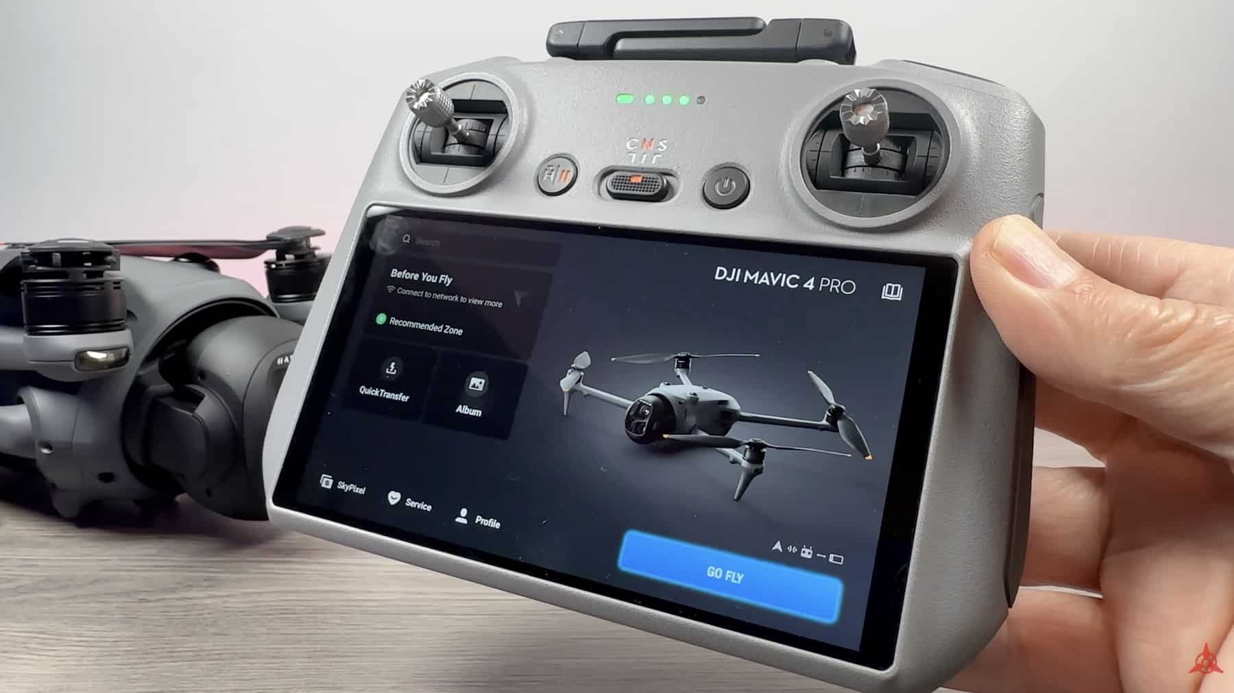 The RC Pro 2 shows its Mavic 4 Pro pre-flight screen with the drone behind.