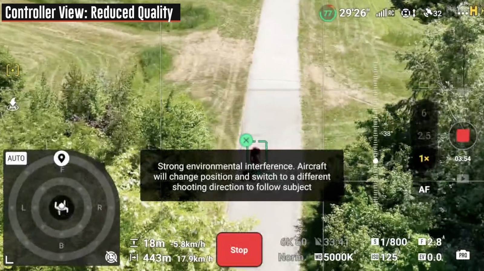 An on-screen warning about strong environmental interference appears above a gravel track.