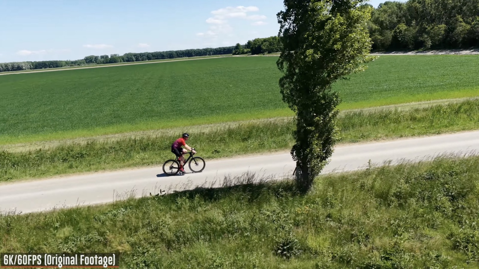 Mavic 4 Pro trailing the cyclist on open road at about 15 mph (24 km/h).