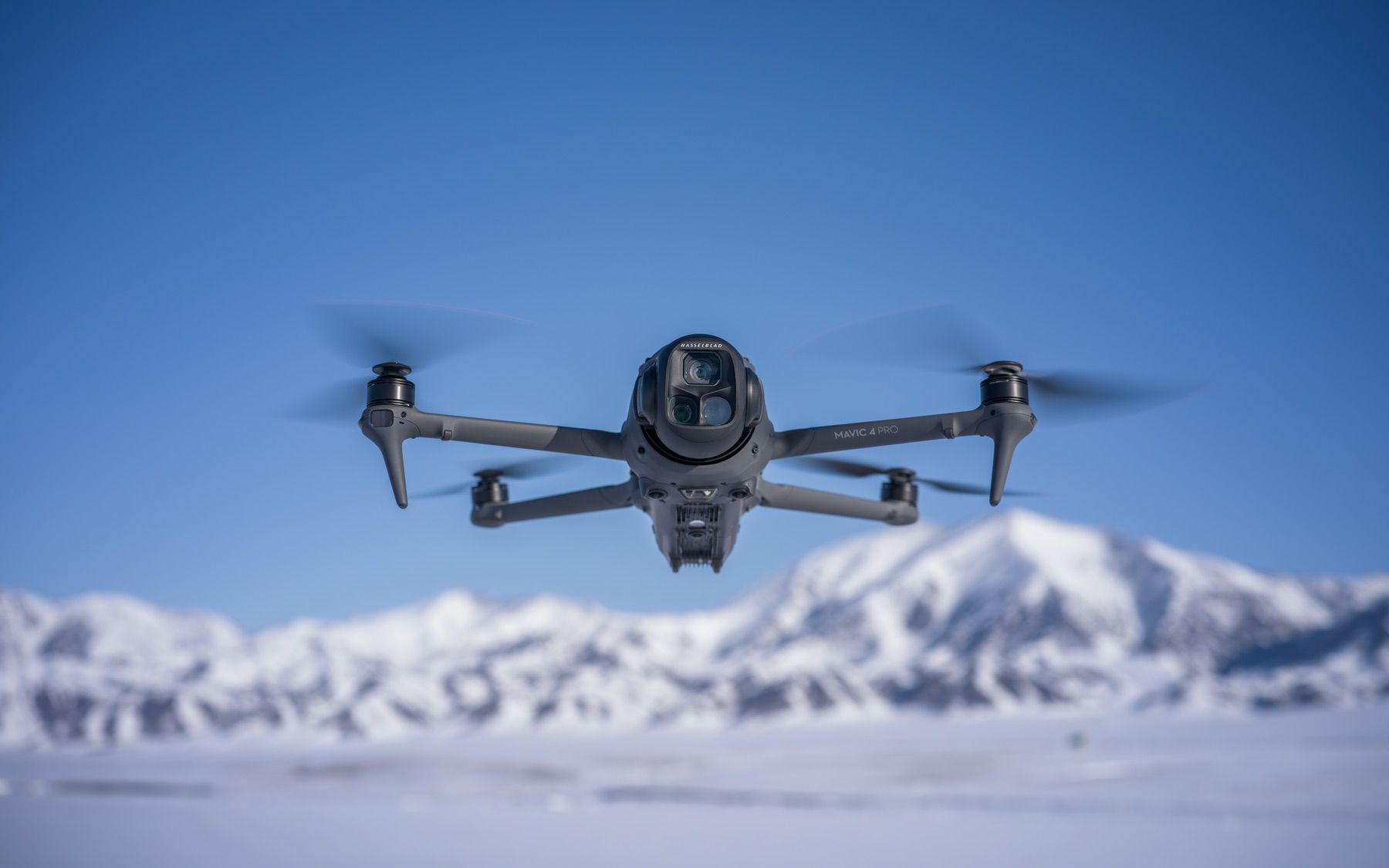 The Mavic 4 Pro banking through a turn with all four arms extended.